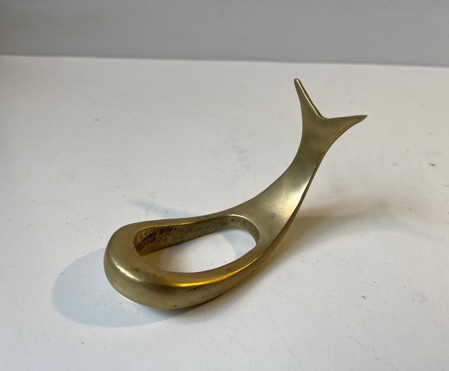 A vintage pipe stand / holder in the shape of a whale / fish. Its executed in solid brass. Originally sold at Illums Bolighus in Copenhagen during the 1950s. It may have been manufactured by Wiener Werkstatte in Austria but it has no markings.