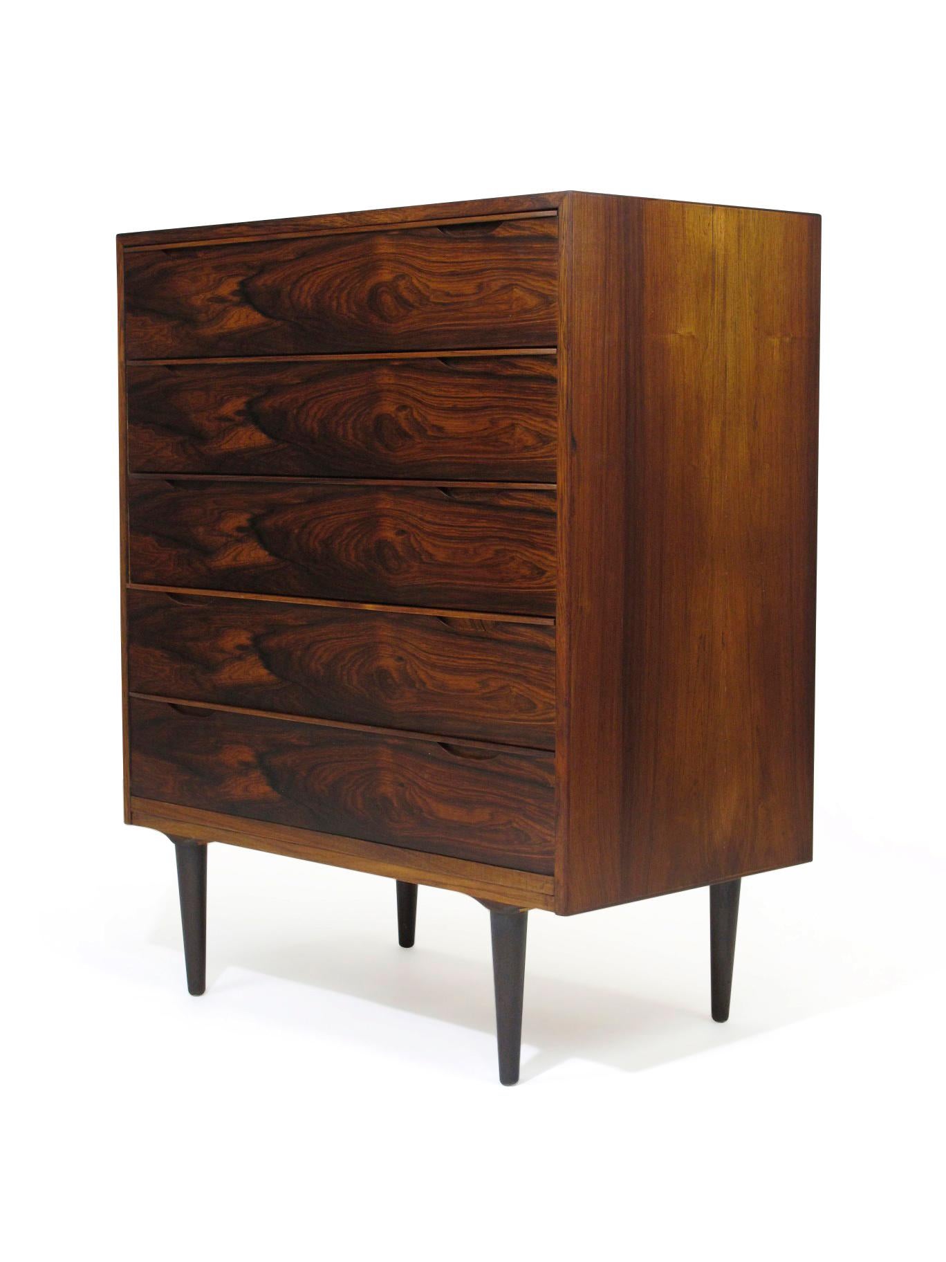 Mid-century Danish dresser crafted of Brazilian Rosewood with stunning pattern match on front of drawers. Interior drawers of cuban mahogany with lounge and grover joinery, top drawer with dividers. The finely crafted cabinet has mitered edges and