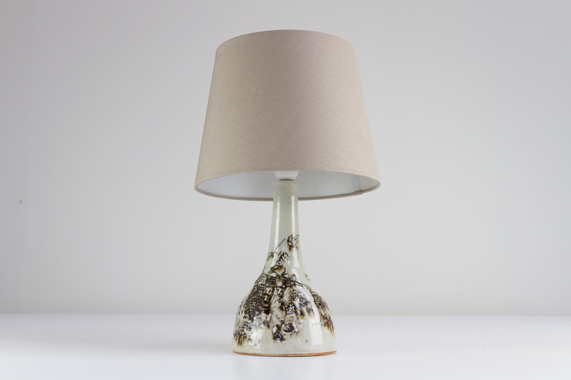 Vintage Danish Brutalist Ceramic Table Lamp by Conny Walther, 1960s.
Danish Mid-century modern table lamp in stoneware designed by Danish ceramist Conny Walther. The lamp base has abstract decorations in tactile brown colors. 
New lamp shade