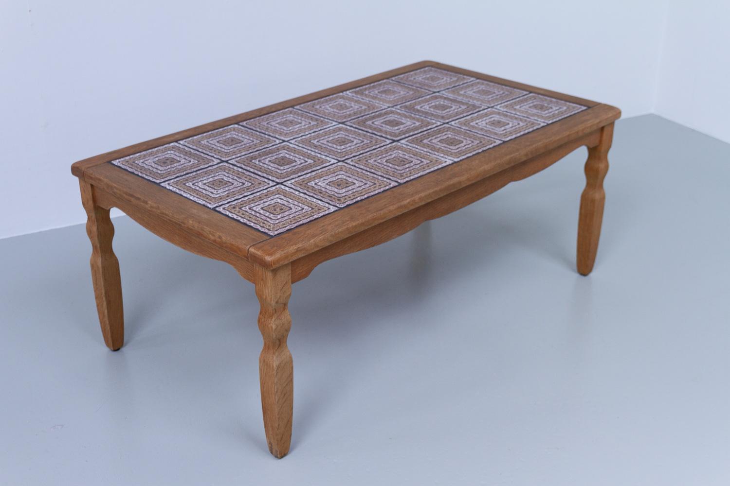 Vintage Danish Brutalist Coffee Table in Oak with Tiles, 1960s.
Danish Modern brutalist style coffee table in solid nordic oak. Inlaid with ceramic patterned tiles. 
Good vintage condition. All tiles are intact. Minor wear to the wood, please see