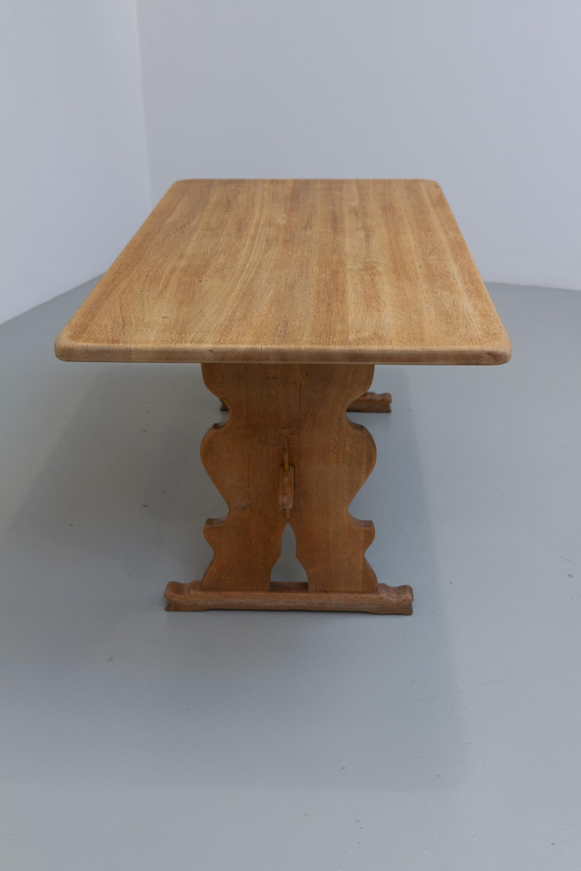 Vintage Danish Brutalist Oak Dining Table, 1960s.

Large rectangular Scandinavian Mid-Century Modern Brutalist dining room table in solid untreated Nordic white oak attributed to Danish designer Henning Kjærnulf.
This rustic looking farmhouse style