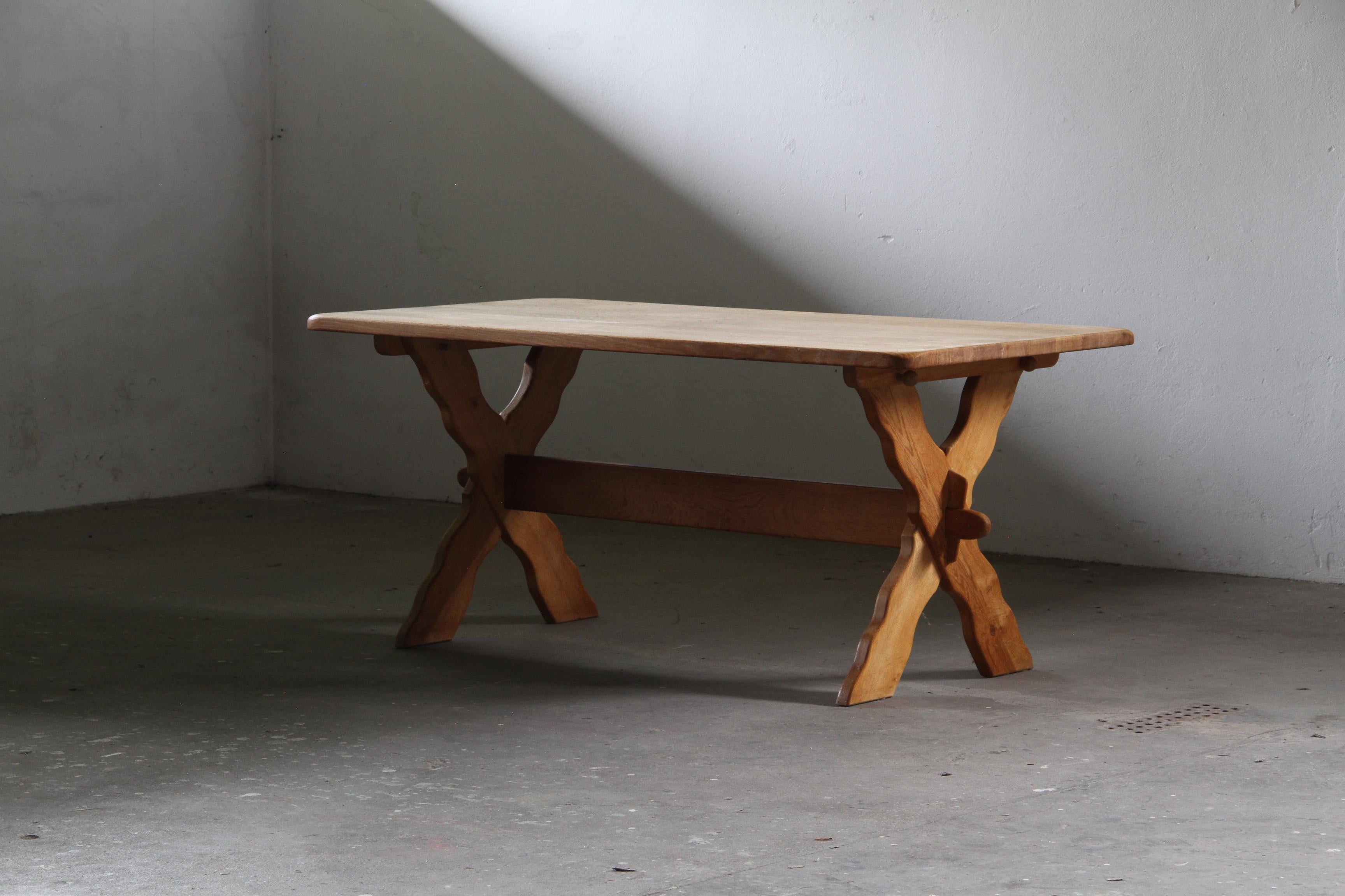 Presenting a unique and beautiful dining table that commands attention through its raw, Scandinavian power and architectural presence. Attributed to the visionary designer Henning Kjærnulf, this piece is a masterful example of Danish Brutalist