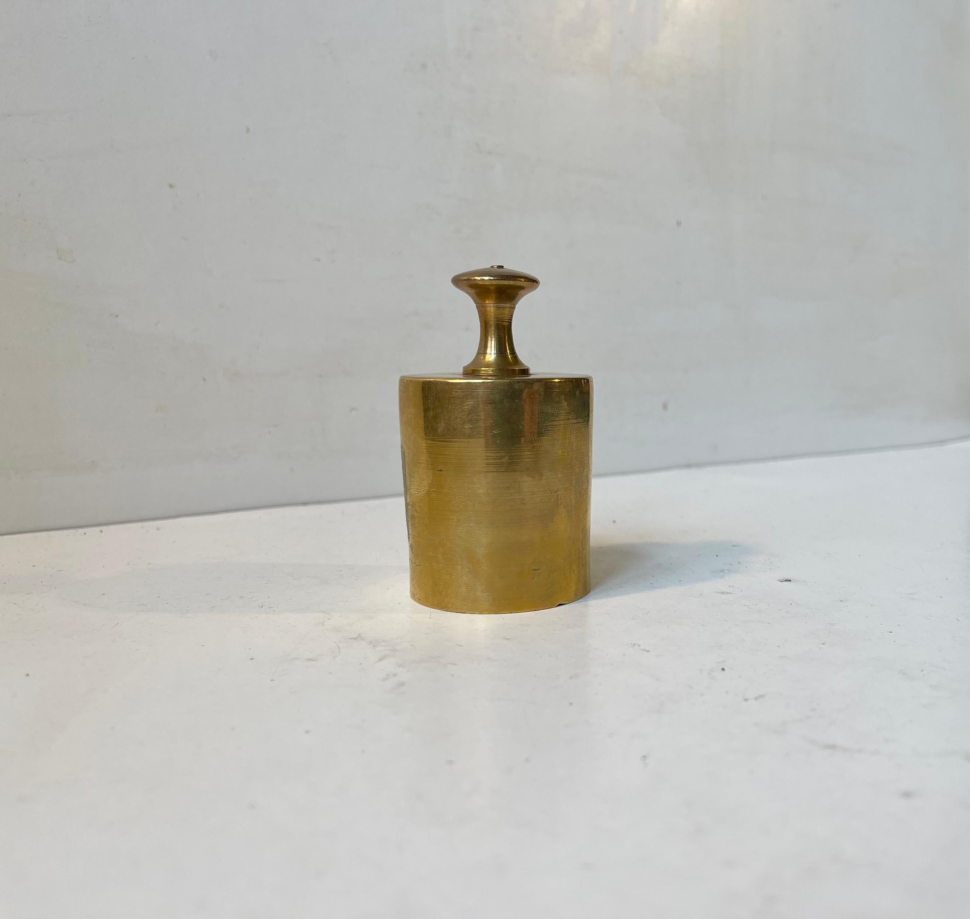 A stylish weight shaped servant bell in solid brass. Prank or be serious when you 'call' your husband or wife to service you on the terasse or balcony. It was made by Cawa in Denmark during the 1970s in a style reminiscent of Carl Auböck.  