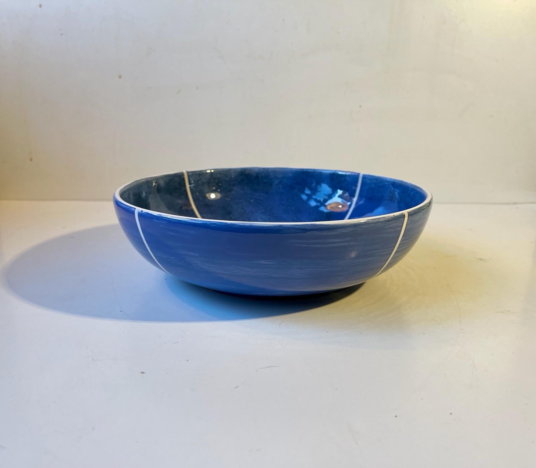 Danish ceramic fruit bowl or centerpiece featuring a 'sky-like' blue glaze highlighted with diagonal white lines and edge. Anonymous Danish designer/maker TVK ca 1980. Measurements: D: 23, H: 6.7 cm.