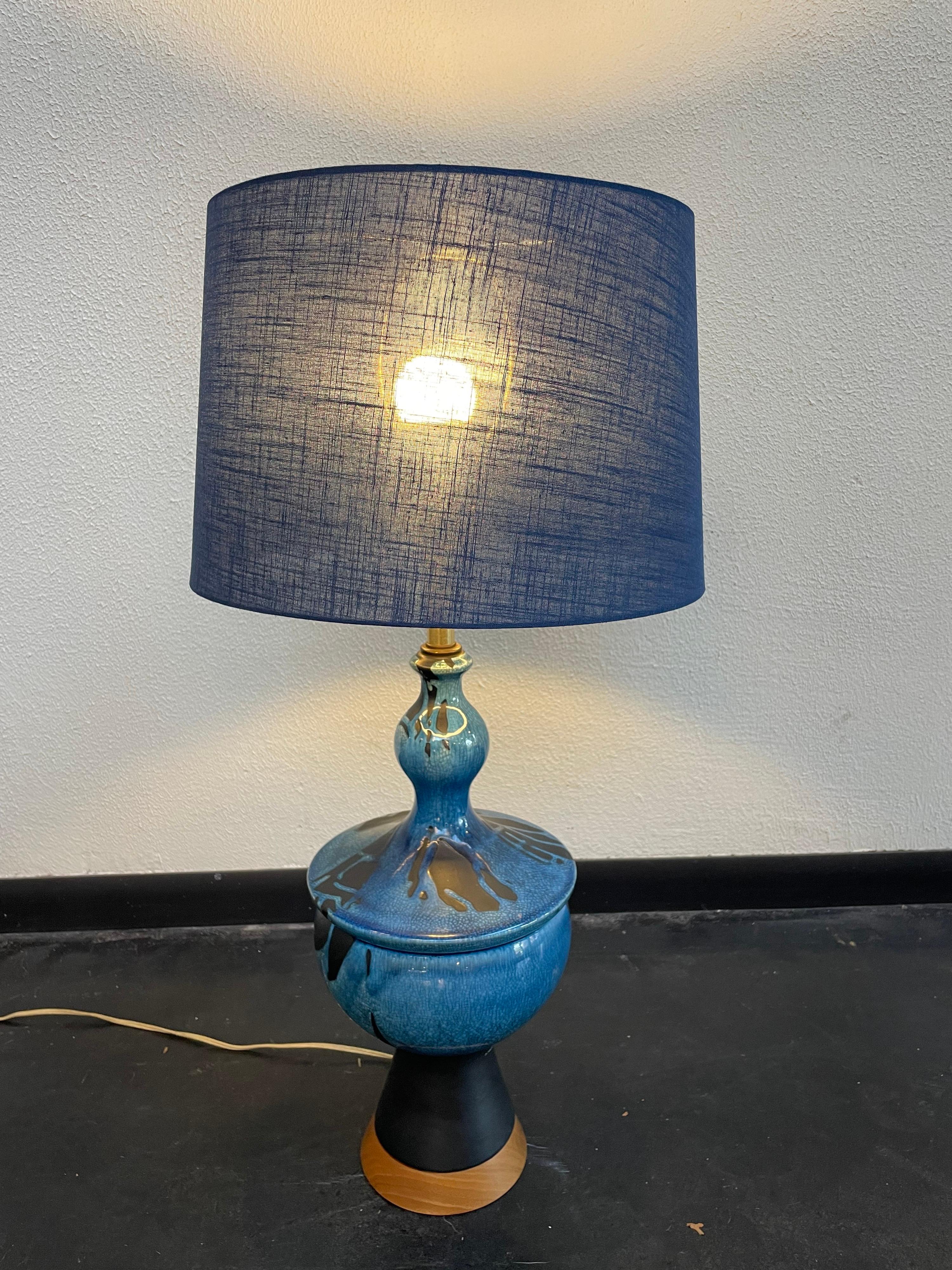 Gorgeous blue Danish ceramic table lamp featuring a wooden base. Shade included.