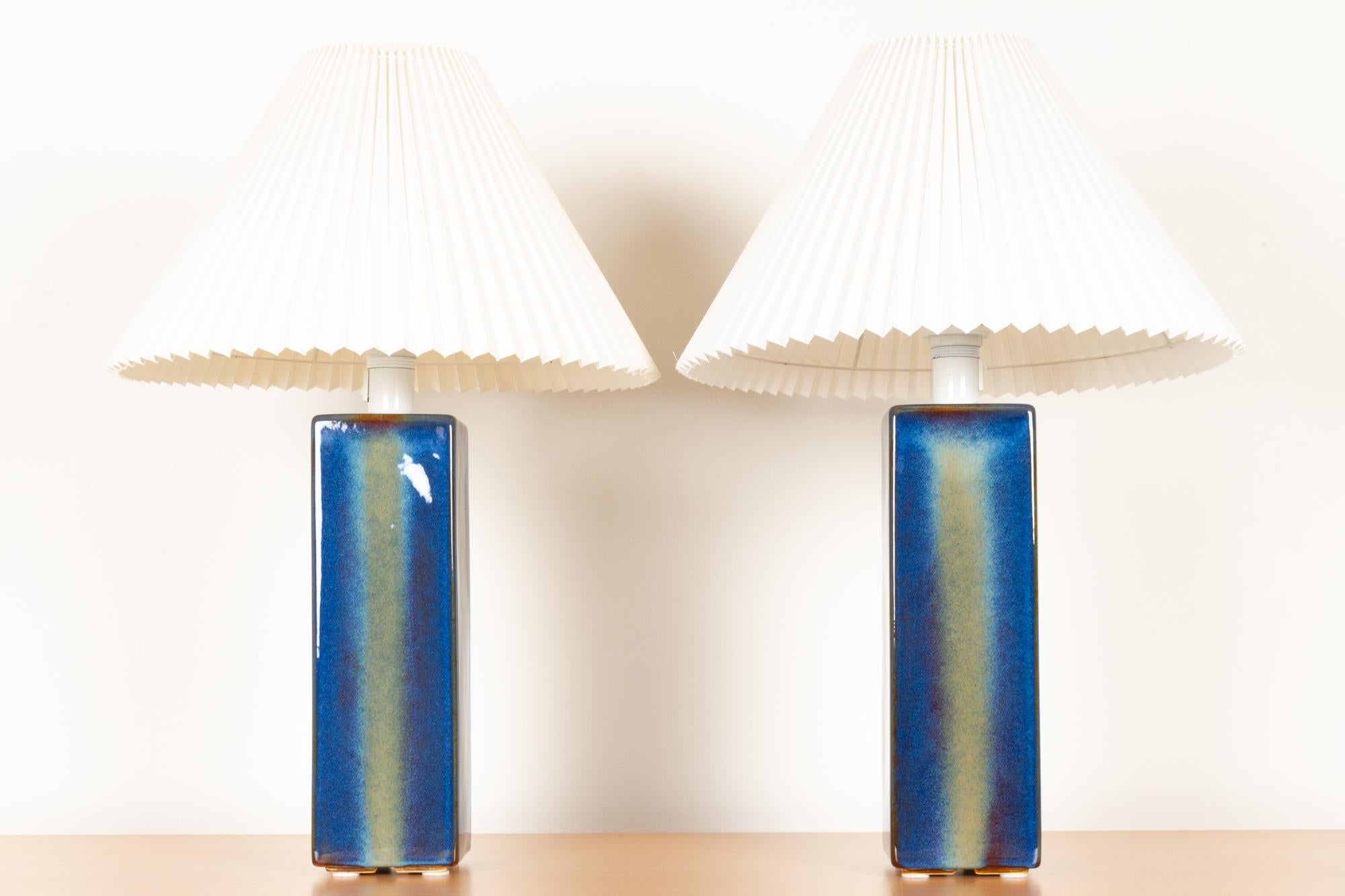 Vintage Danish ceramic table lamps by Søholm 1960s set of 2
Pair of tall Danish Mid-Century Modern table lamps in stunning blue and green glaze with pleated white shades. Handmade on the small Danish island of Bornholm. 
Size of the lamp body