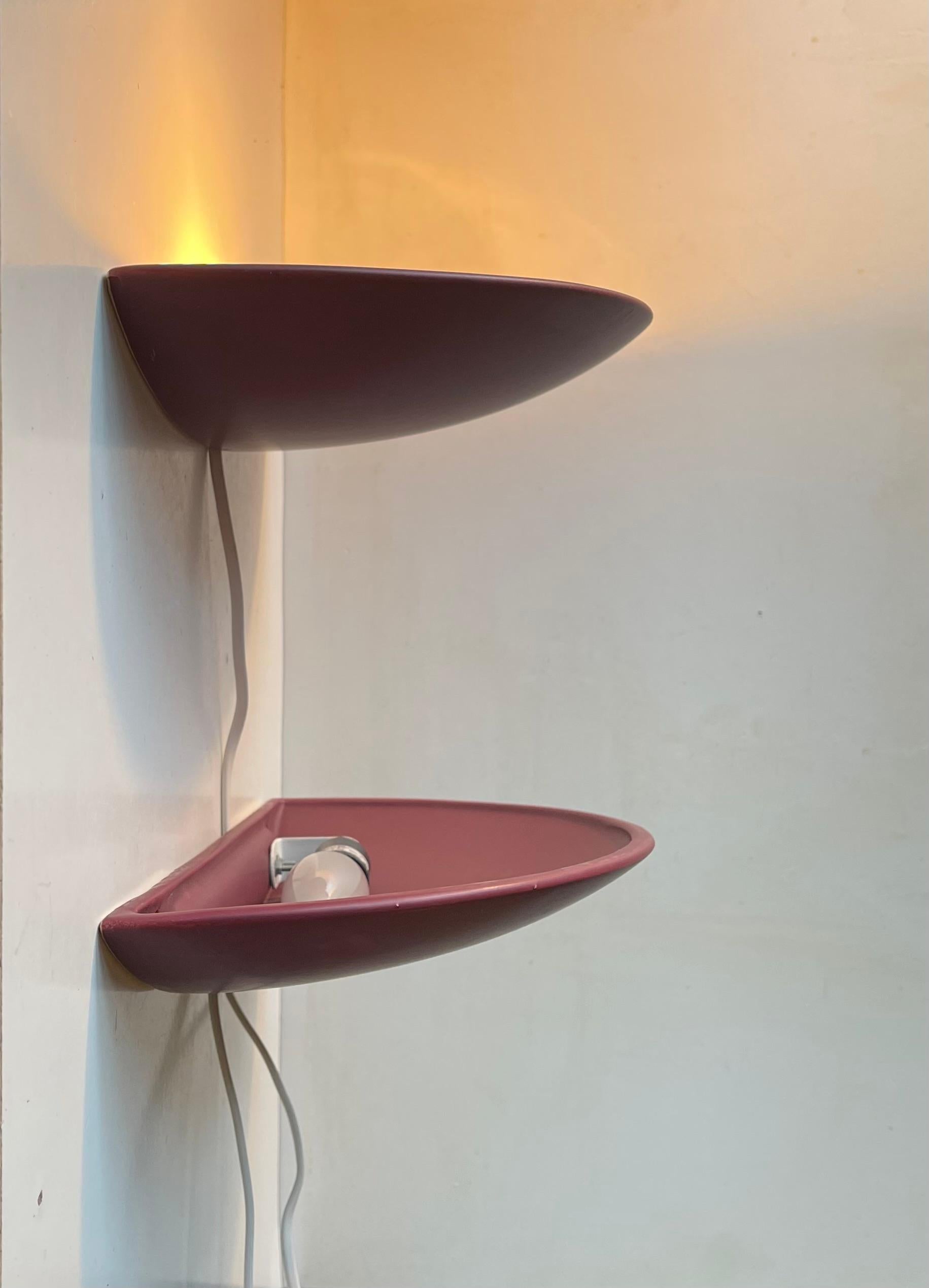 A pair of large ceramic up-light wall lights with a plum type magenta semiv-matté glaze. Manufactured in Denmark during the 1980s. E14 bulbs/sockets up to 40 watts. Measurements: W: 35 cm, Dept: 18 cm, Height: 5 cm. The price is for the set of 2.
