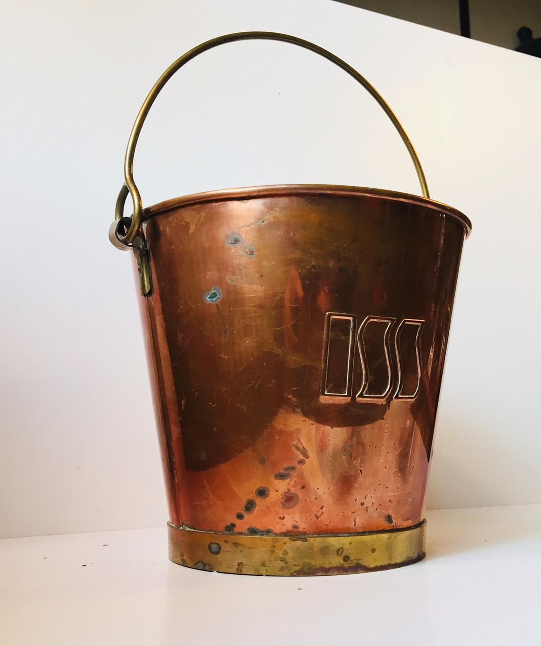 Large champagne ice bucket fashioned out of copper and brass. The interior is plated with white metal. The bucket is stamped Darlin to the base and is was commissioned by the Danish Company ISS who operates out of Copenhagen and specializes in