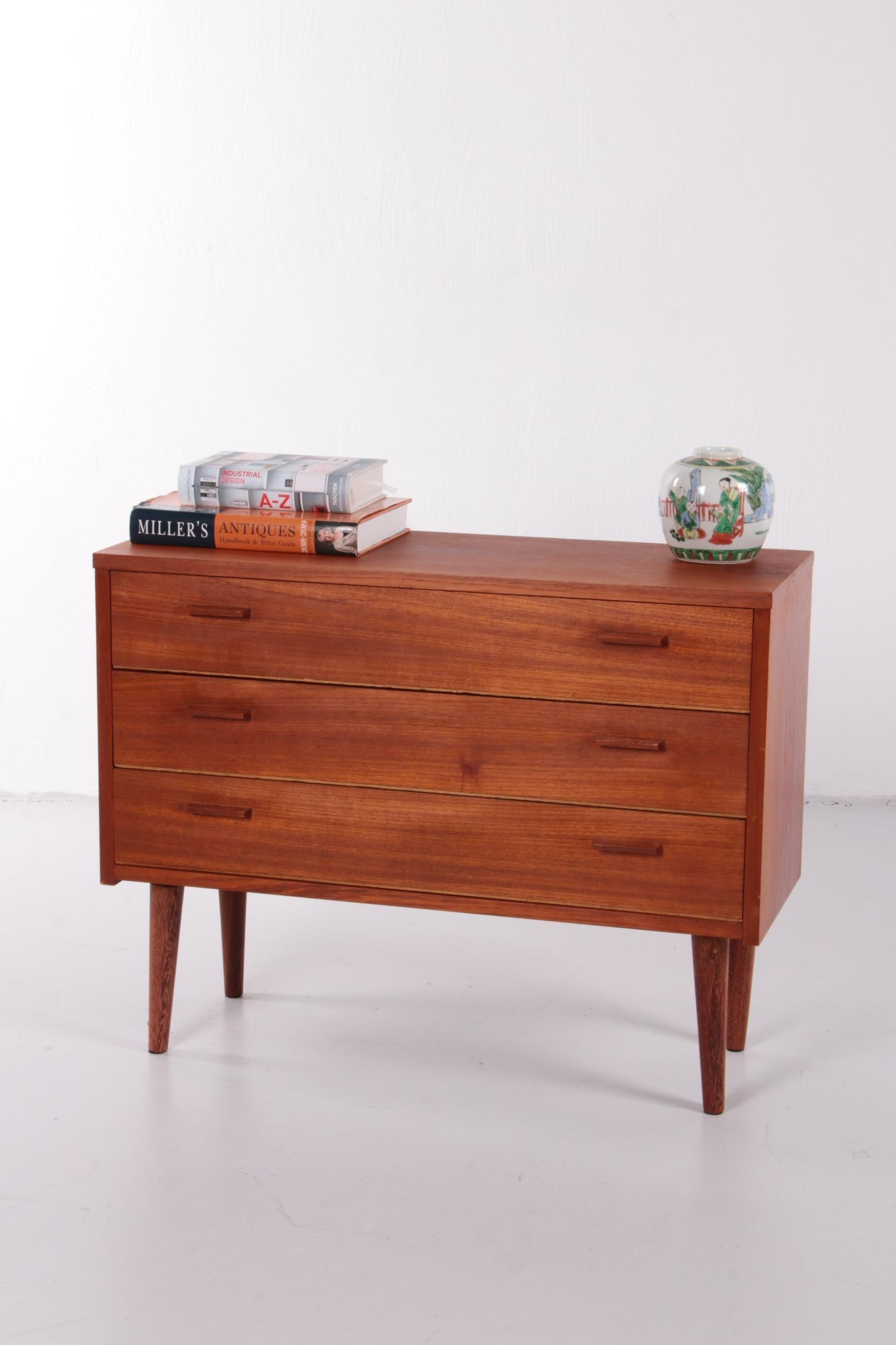 A beautiful chest of drawers from Denmark. The cabinet was probably produced around the 1960s and is made of veneered teak, which gives the cabinet a nice warm color.

This cabinet has three drawers for quick storage of all your belongings. The