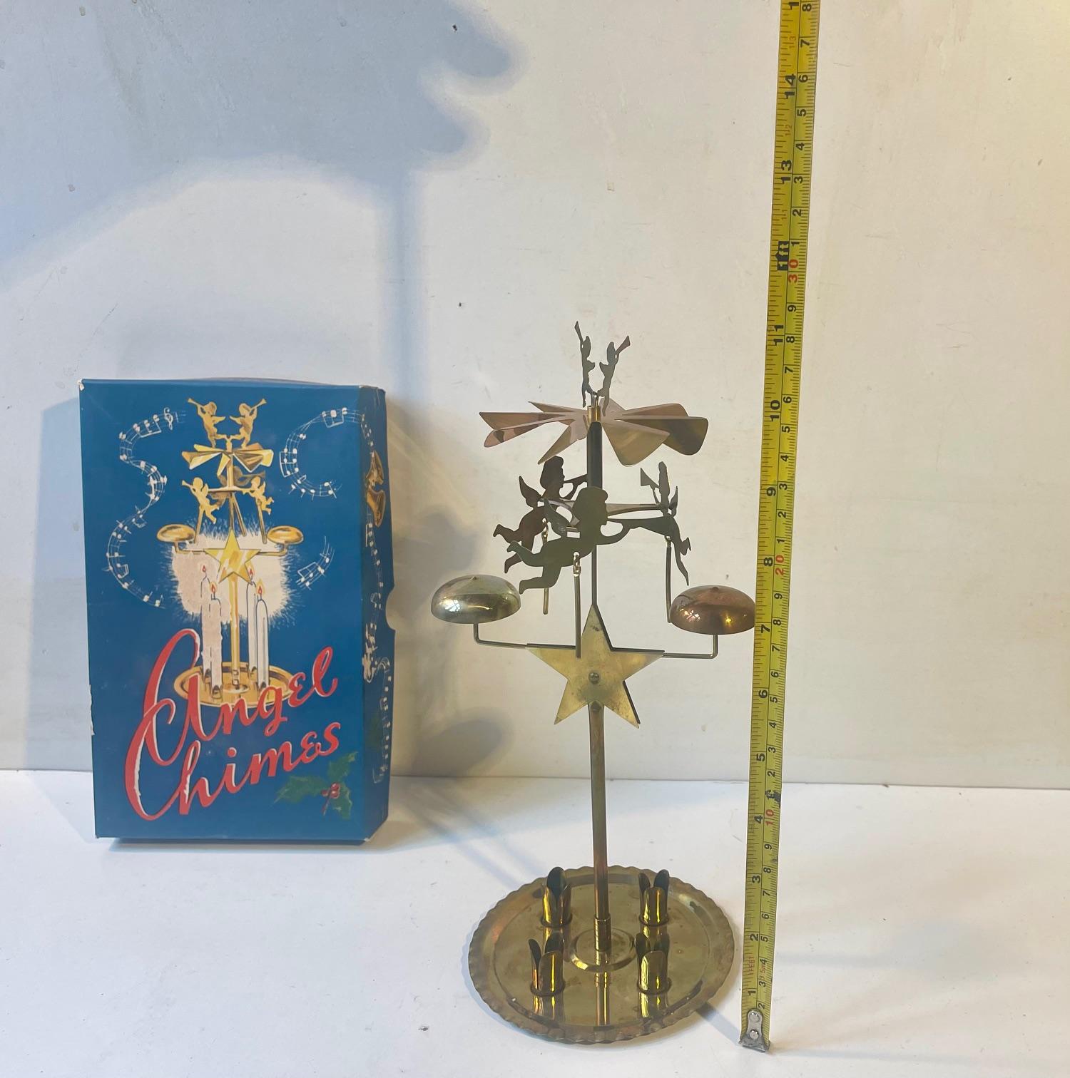 This vintage MEKA No. 274 set of angel chimes was made in Denmark during the 1950s or 60s. The assembled brass parts rotate on a socket with 4 candles providing the heat for convection to spin the rotor. It comes in its original paper box from Meka