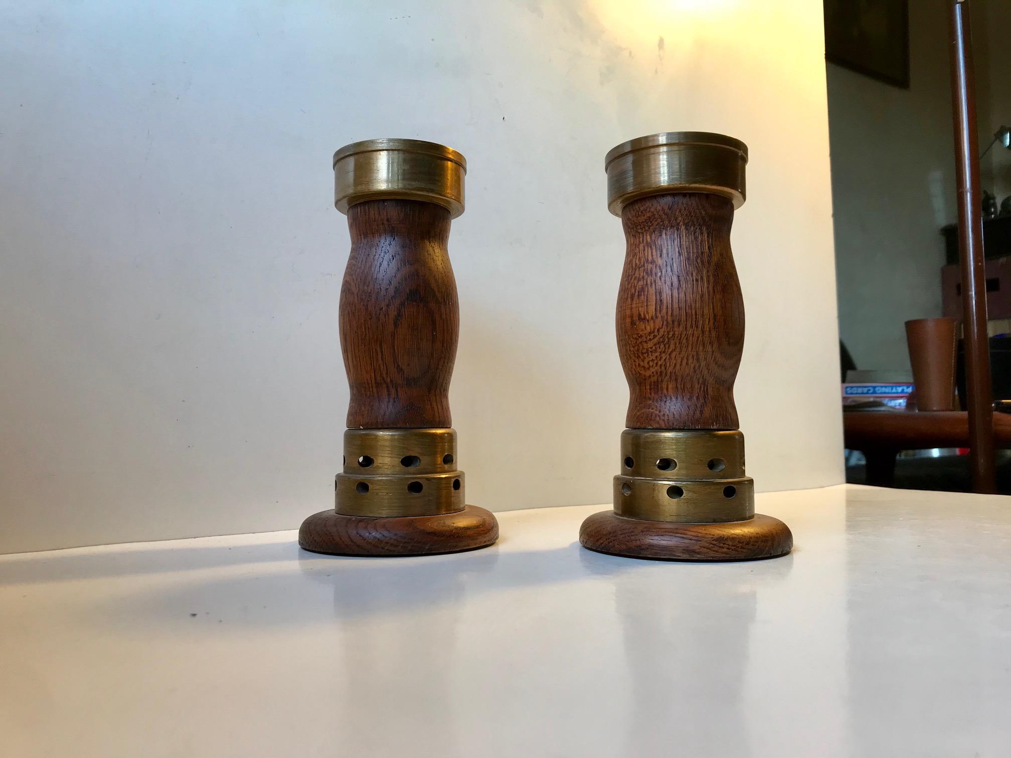 A pair of church candlesticks in oak and partially cross drilled bronze. These came out of a Church Near Vejen in the Eastern part of Denmark. The design is very plain and almost has an Art Deco appearance to them. They have not been polished