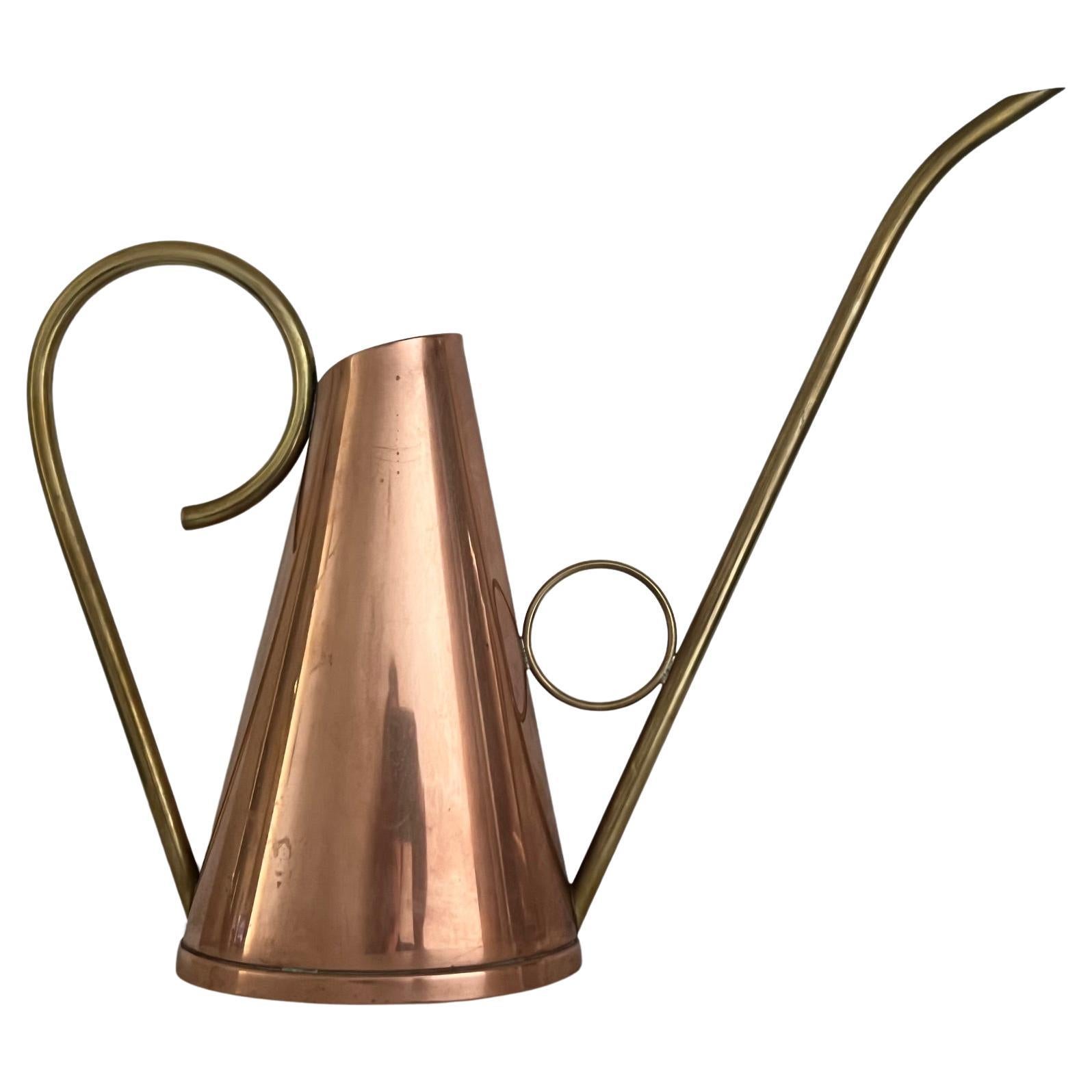 Vintage brass and copper watering can made in Denmark, stamped Haandarb. The part that holds water is 7.6