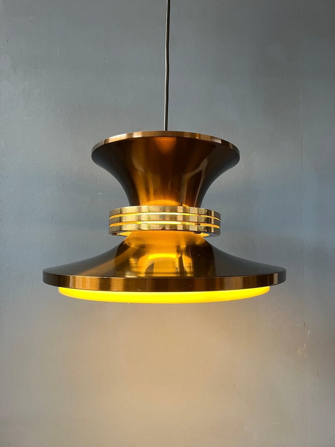 Vintage Danish pendant lamp in copper colour. The aluminium layered lamp creates a beautiful reflection of light. The lamp requires one E27/26 (standard) lightbulb.

Additional information:
Materials: Metal, plastic
Period: 1970s
Dimensions: ø