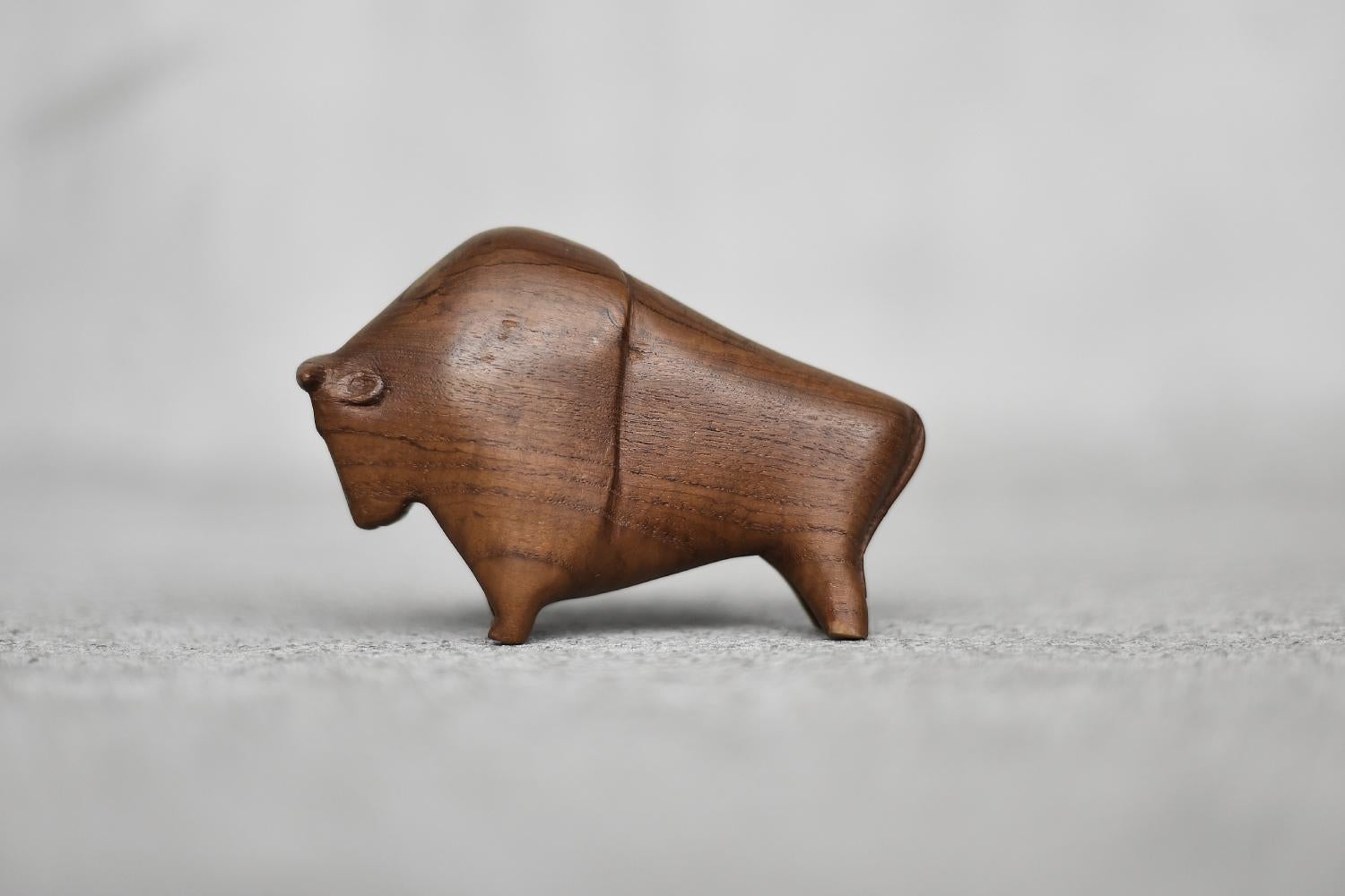 This wooden figurine of a Bison was made in Denmark during the 1960s. Hand-made of high-quality teak wood with clearly visible grain. The minimalist form with simplified details reflects the character of the animal in a style typical of Danish