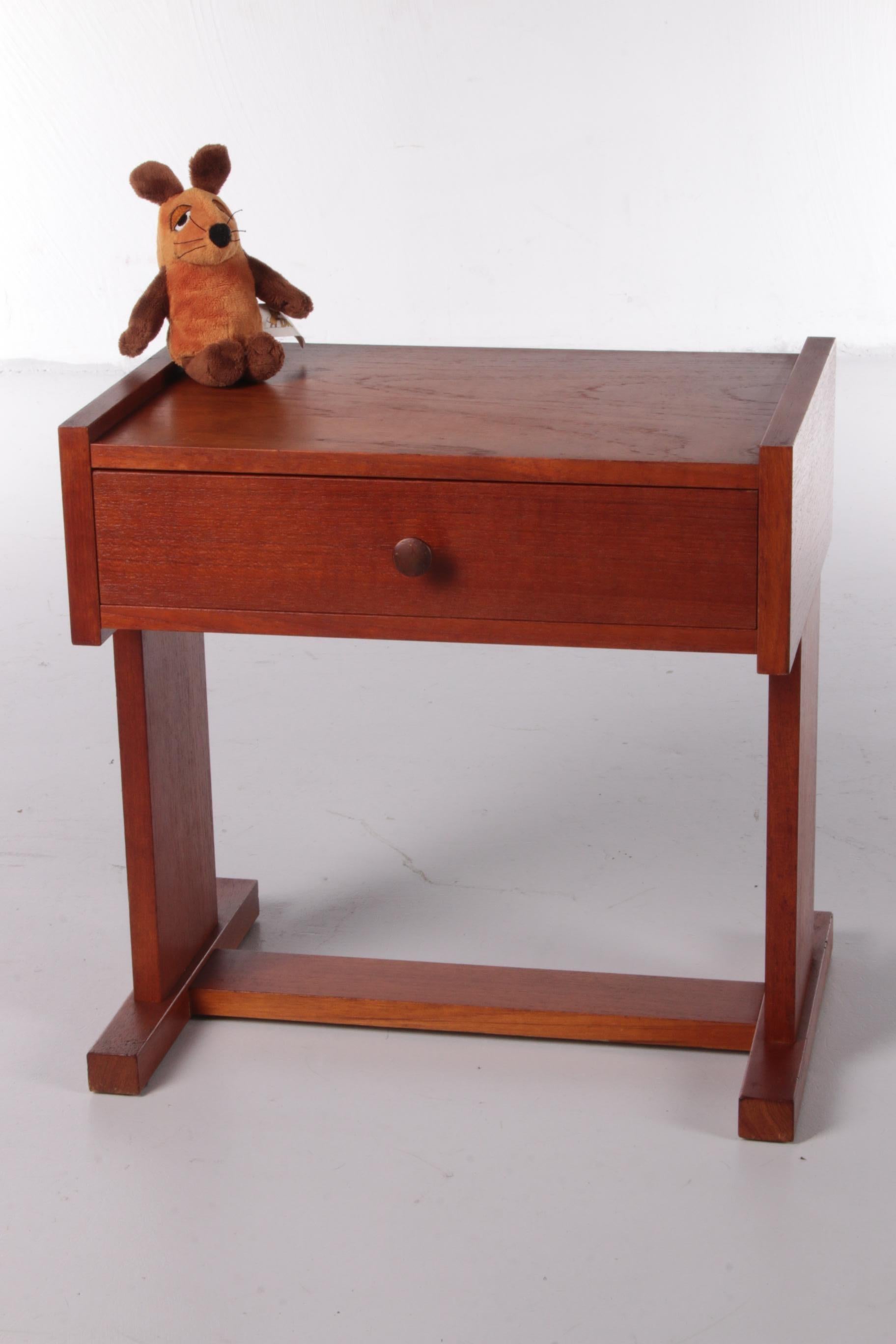 A nice compact Danish bedside table from the 1960s.

The simple design in combination with the light brown color of the teak gives this cabinet a stylish look.

The bedside table has a handy drawer for storing things.

Very charming legs that
