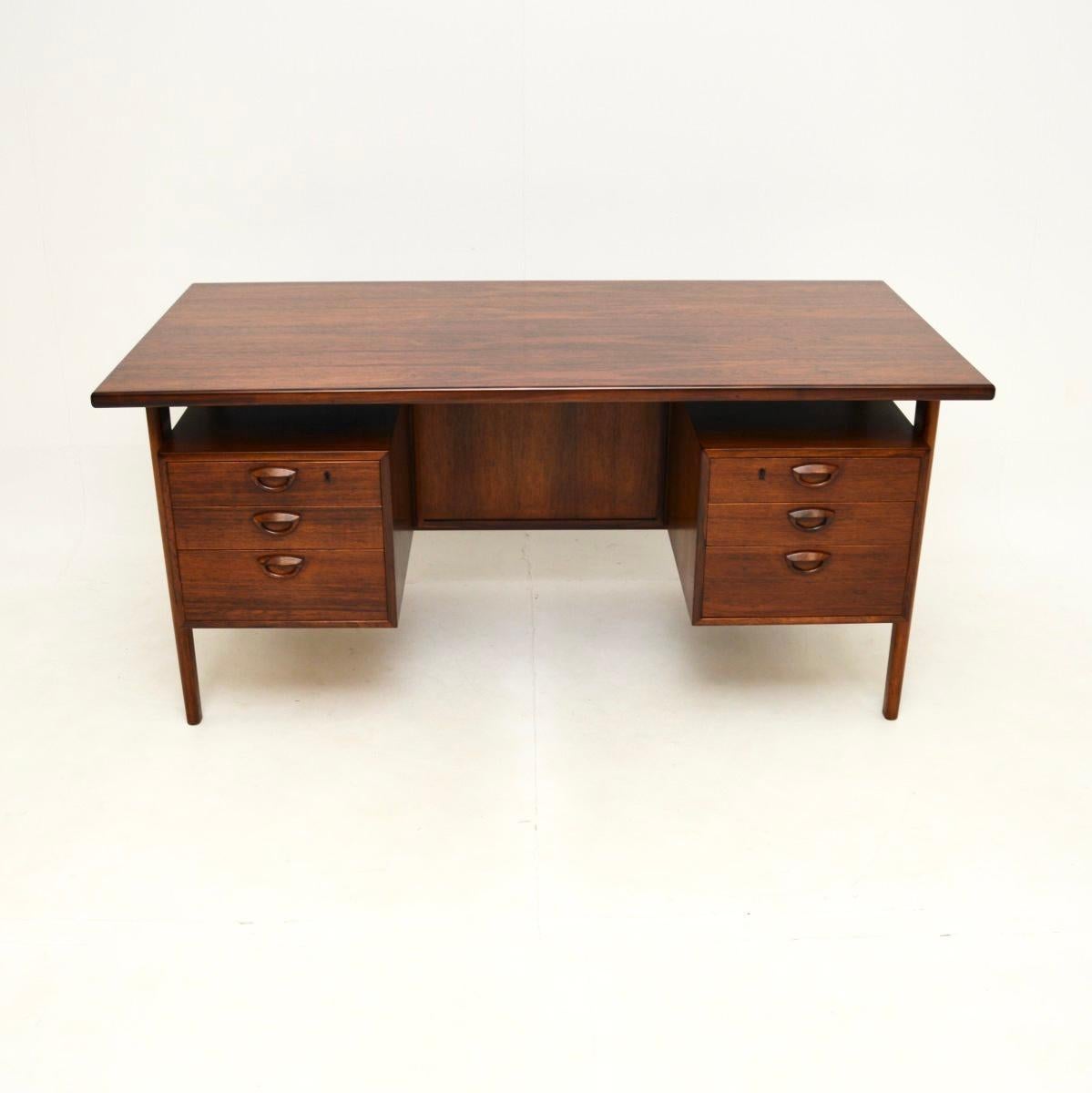 A magnificent vintage Danish desk by Kai Kristiansen, dating from the 1960’s.

It is of outstanding quality, with a gorgeous colour and stunning grain patterns. There is ample work space and storage space in the six drawers. This has a nicely