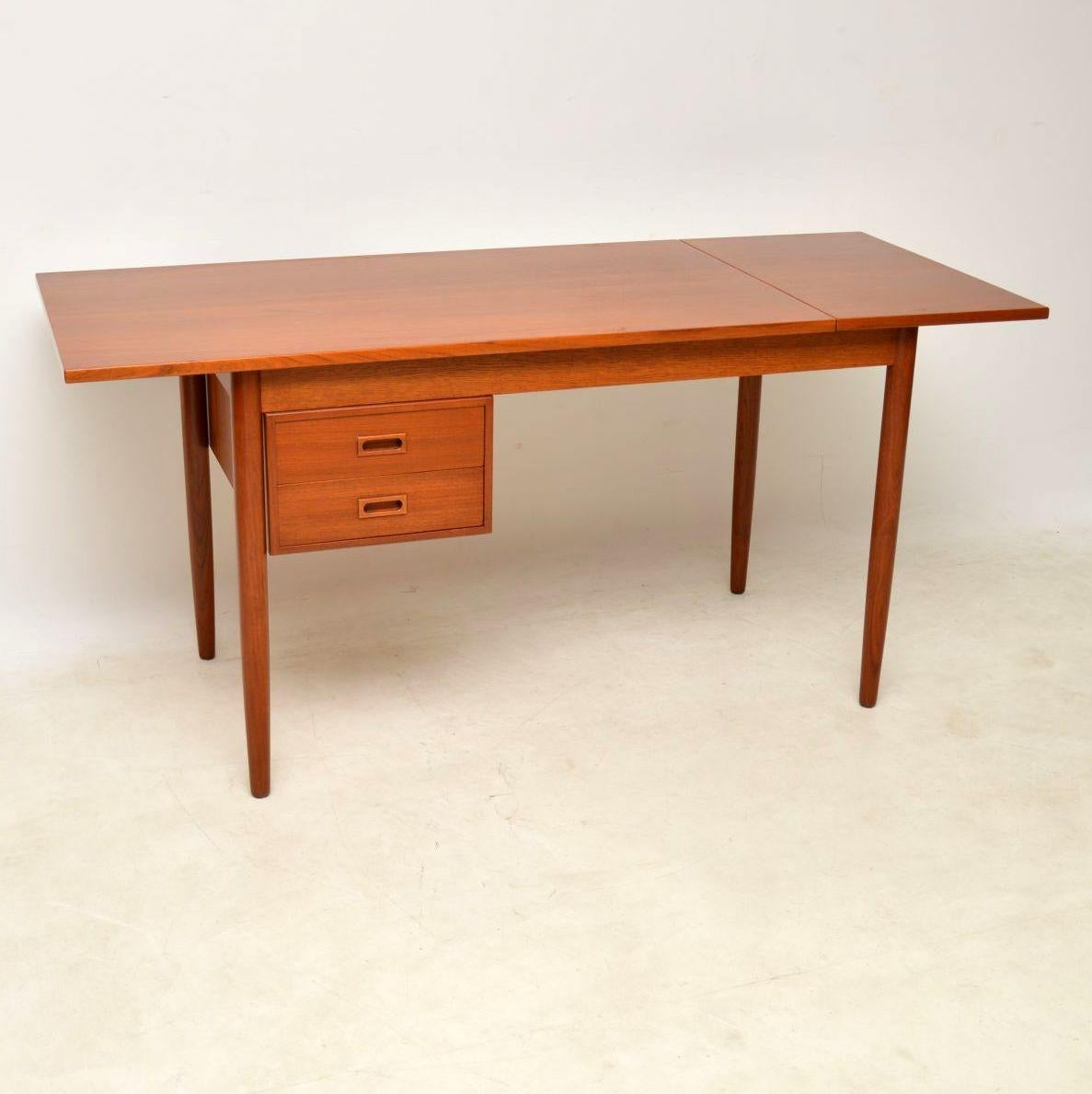 A stylish and extremely well made vintage teak desk, this was made in Denmark, it dates from the 1960s. We have had this fully stripped and re-polished to a very high standard, the condition is superb throughout. The drop down leaf lifts up and can