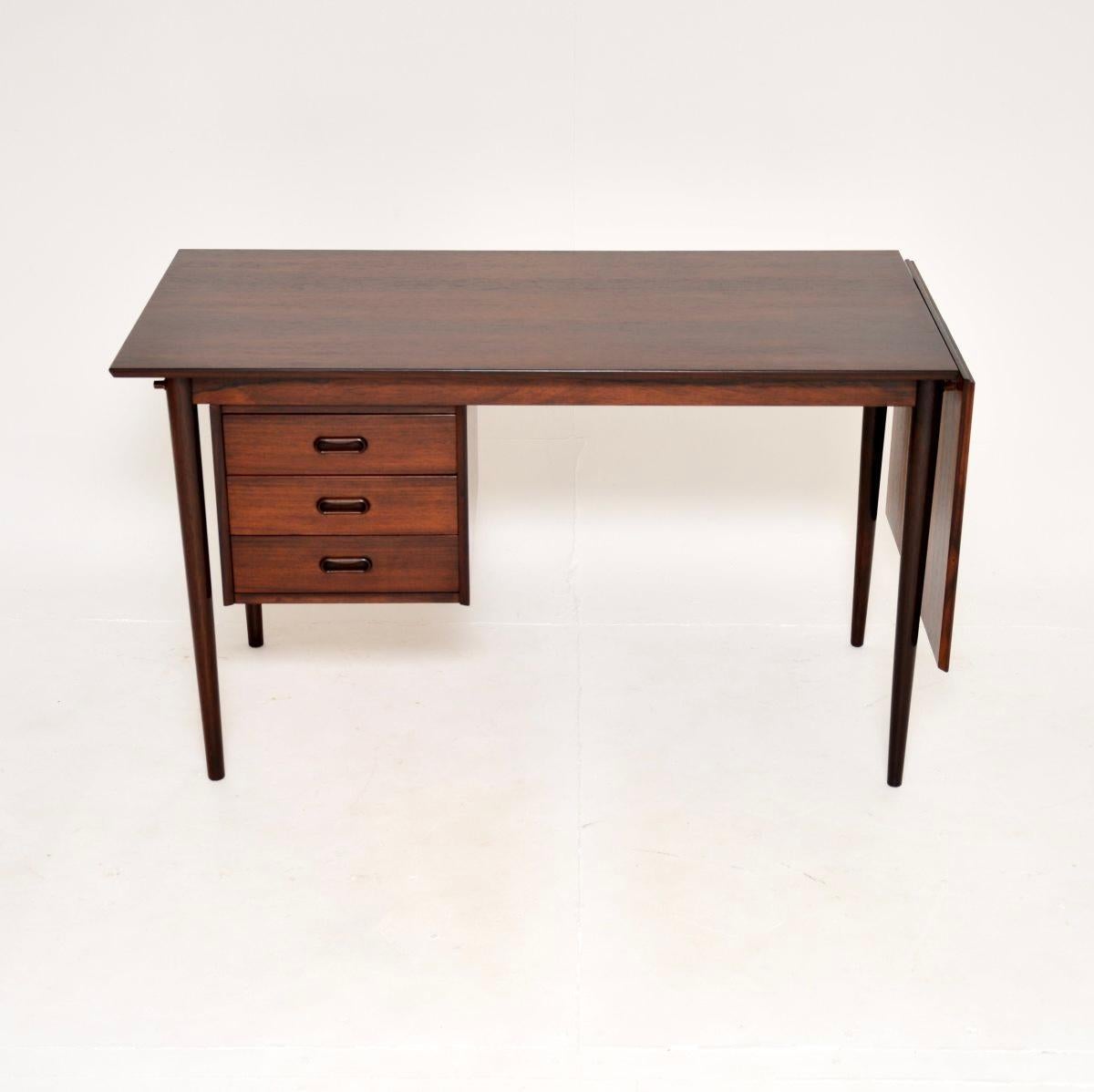 A stylish and extremely well made vintage Danish drop leaf desk, dating from the 1960’s.

This is of amazing quality and has a wonderful design. It is a lovely fairly compact size, with a drop down leaf that lifts up and slides across to extend the