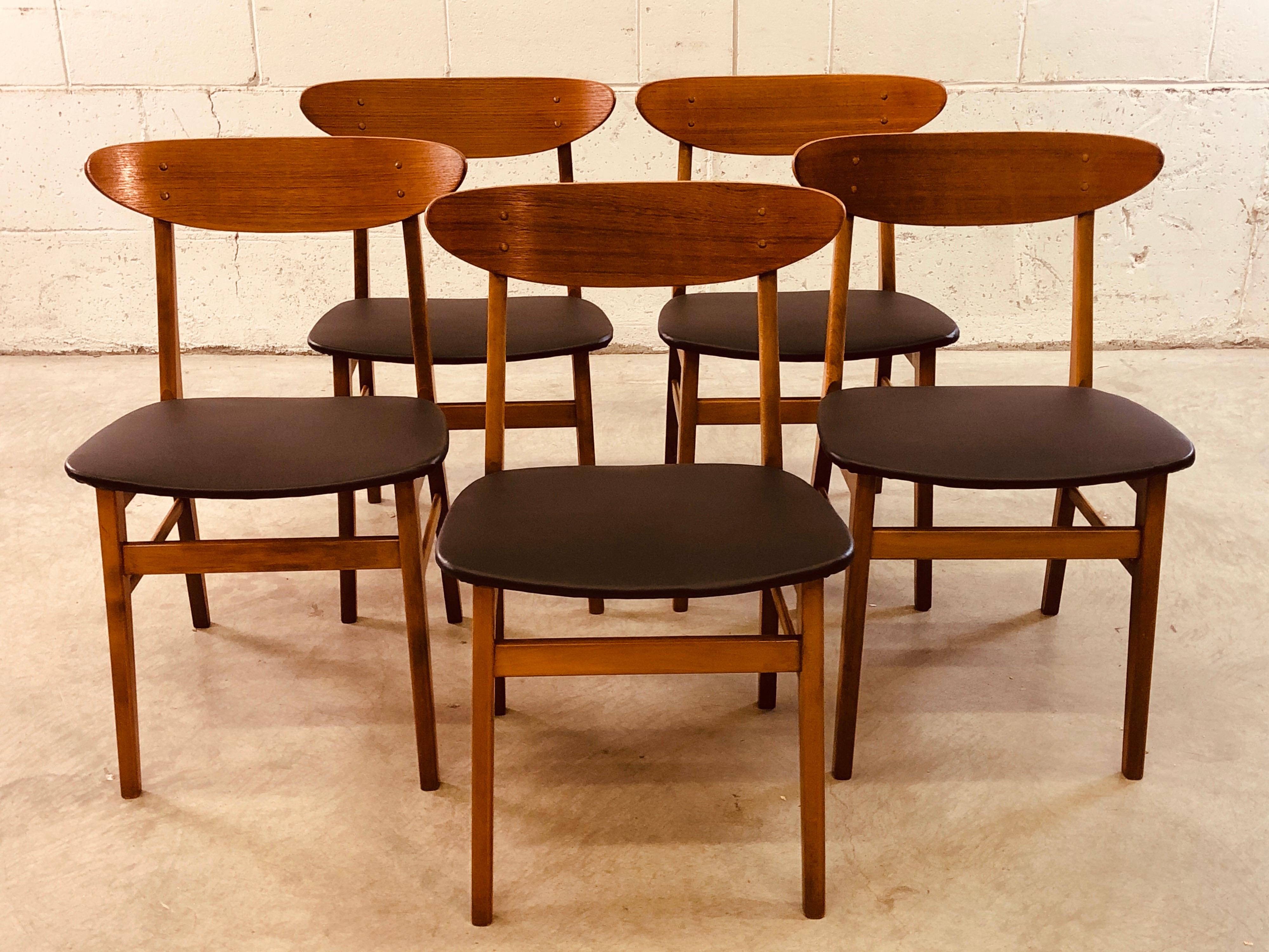 Vintage Danish modern Farstrup Mobler set of five dining chairs on a beech frame with a curved teak surfboard backrest. Chairs have been refinished and restored with new black Naugahyde seats. Marked underneath. Excellent condition.