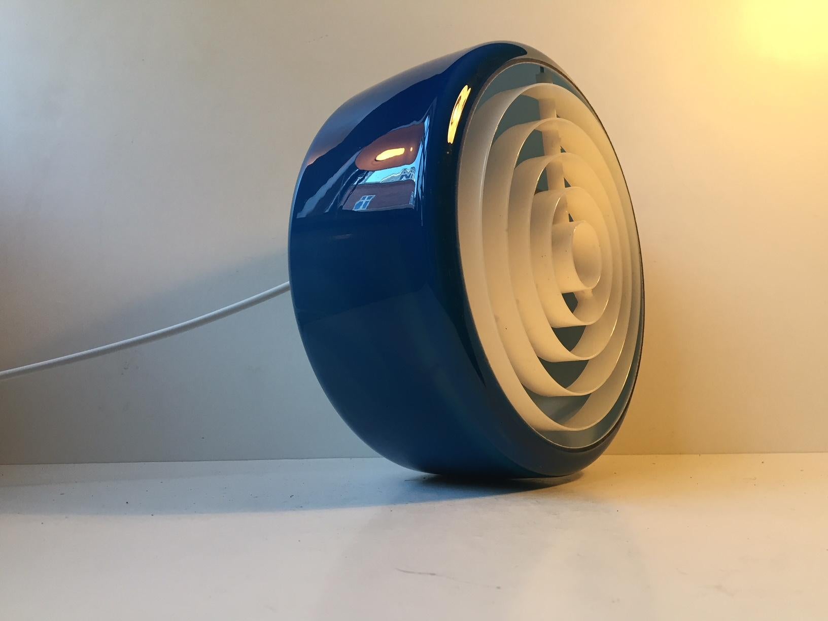A vintage flush mount ceiling lamp designed for rooms corridors with low ceiling heights. It was made in the 1970s by NSC (Nordisk Solar Compagni) in Denmark. The blue cased opaline glass shade was made at Holmegaard for NSC. When lid it turns from