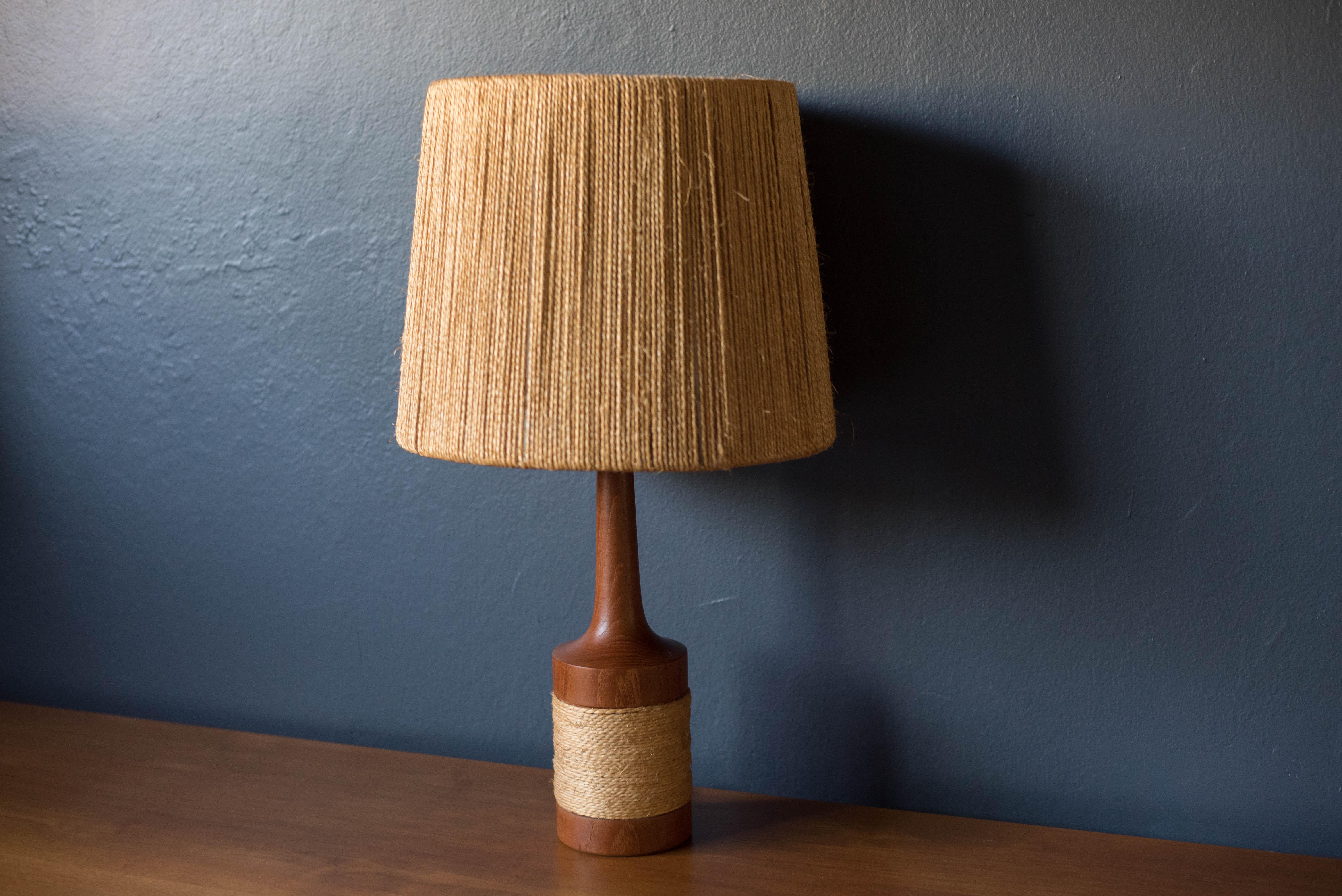Mid century table lamp by Fog & Morup in teak, circa 1960s. This piece is wrapped with jute string and includes the original shade with cover.
 
 