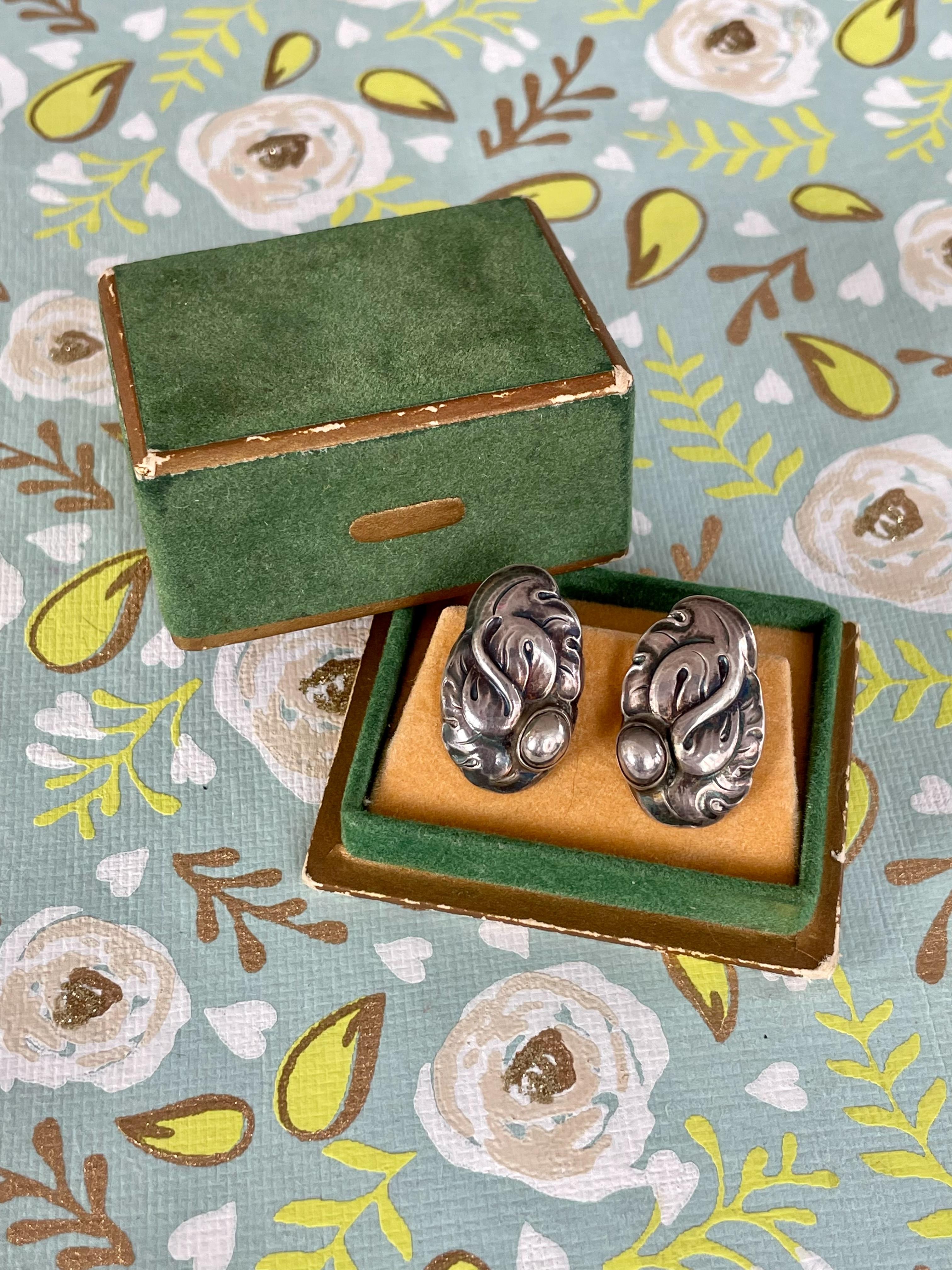 These vintage Georg Jensen Sterling Silver screw back earrings feature a lovely design. Each are stamped 