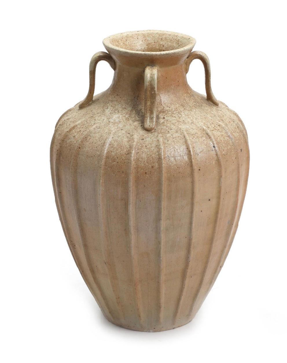 A danish glazed stoneware vase by unknown maker. 

circa 1950s 

Glazed stoneware vase, with four handles and fluted body. Unsigned.

Measure: Height: 12