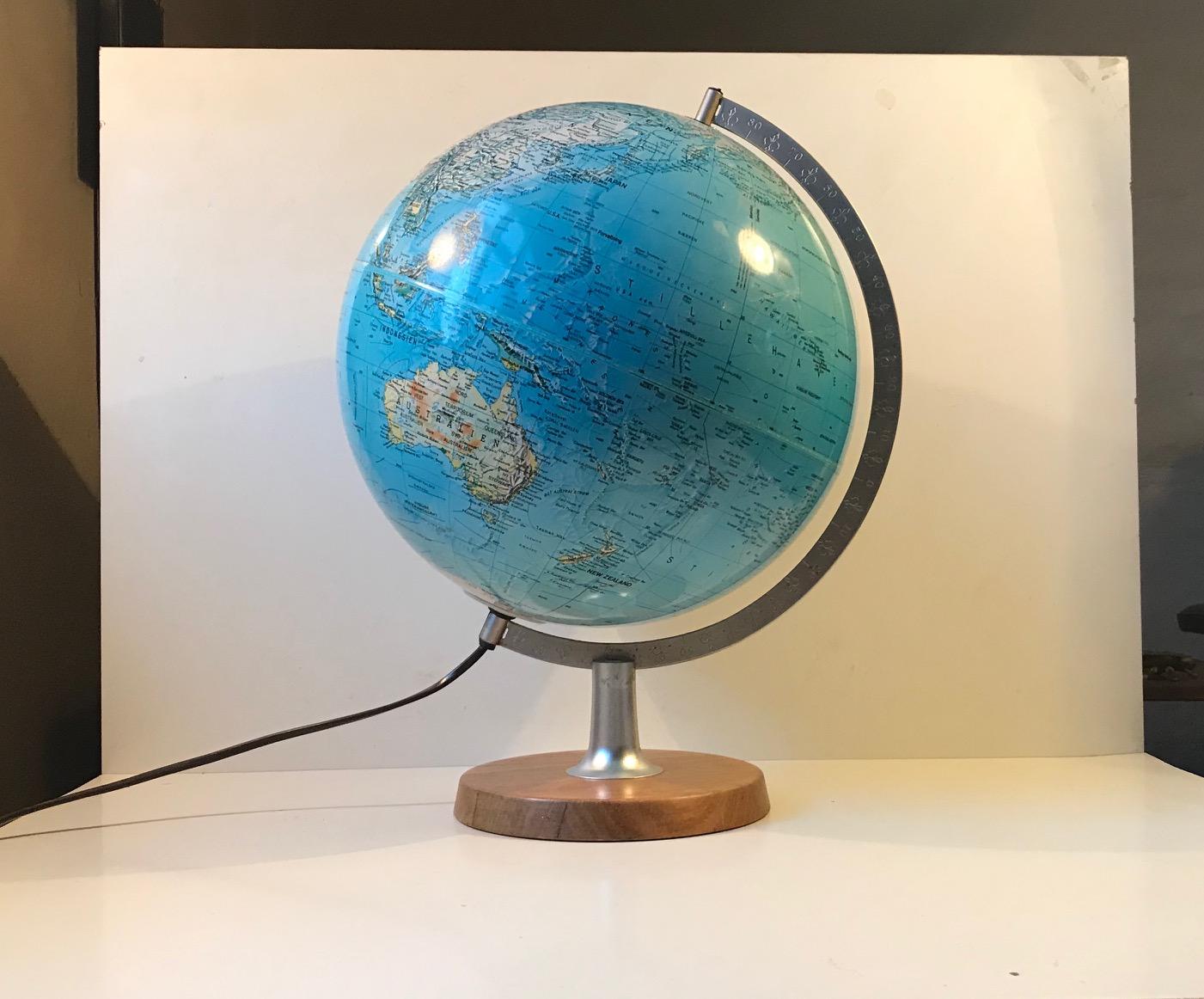 Professional illuminated Globus made from steel, solid teak and poly-resin. It was manufactured and designed by Scan-Globe in Denmark during the 1970s. It has a 40 watts light bulb and it serves as a table light as well. Although countries are