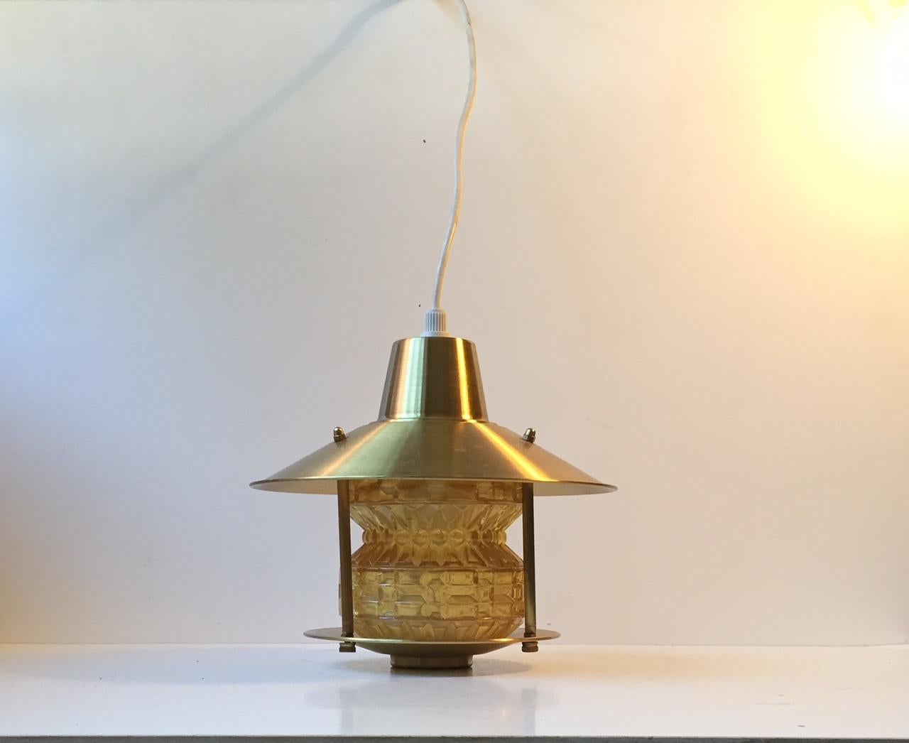 Entrance, corridor or Hallway pendant lamp composed of brushed brass and yellow glass with geometric patterns. It was manufactured by Lyfa in Denmark during the late 1950s. The style of this lamp is reminiscent of Hans-Agne Jakobsson.
