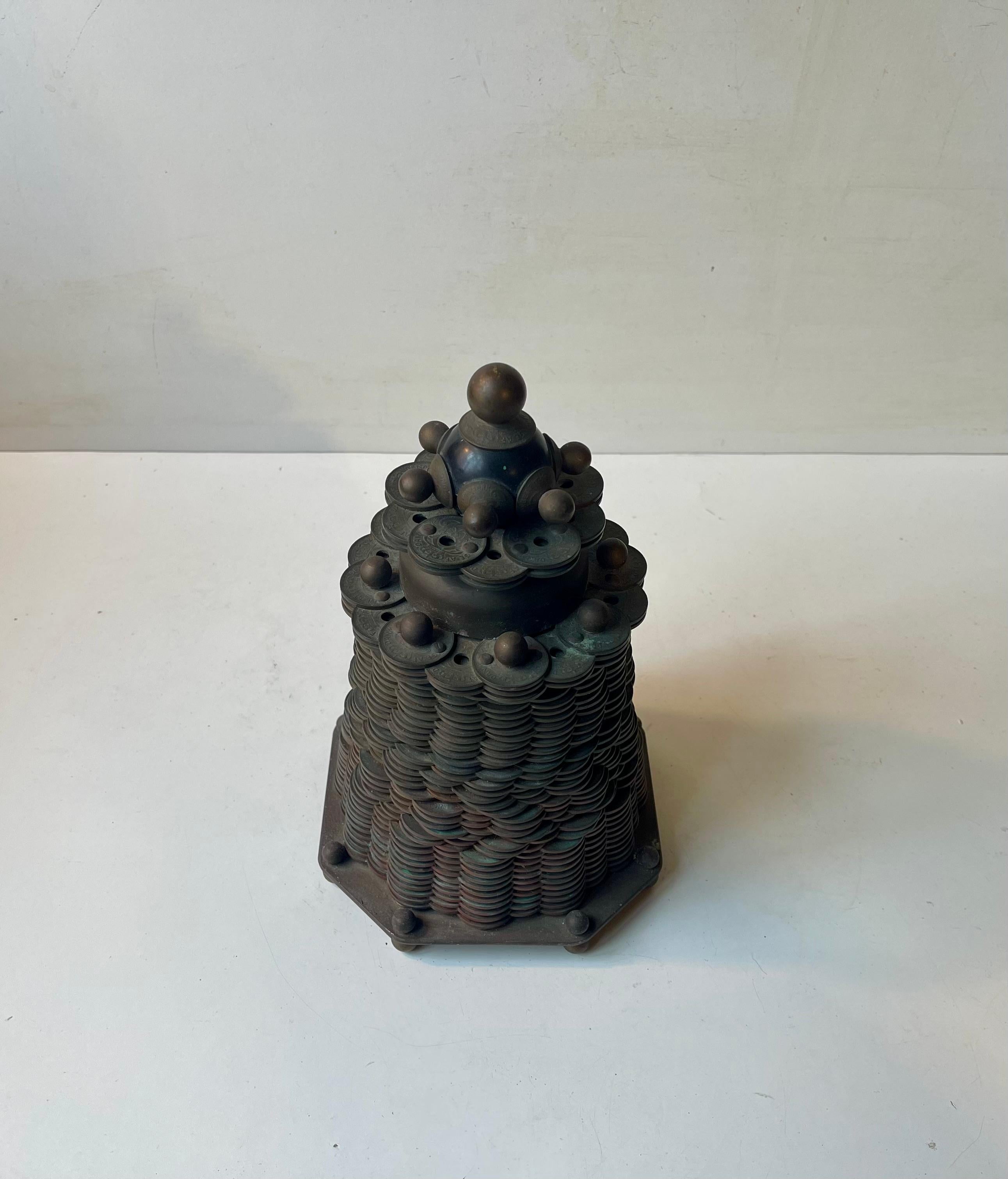 Unusual pagoda shaped coin sculpture called a coin mounain. Legally made in Denmark as an anti-capitalistic manifesto inspired by 'The Pyramid of Capitalist System' ('La Pyramide du systéme capitalist'). In 1973 these smaller valued coins was
