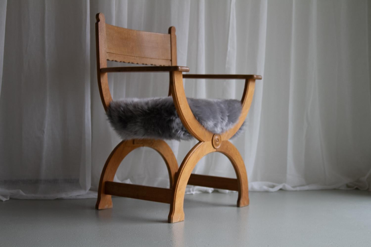 Scandinavian Modern Vintage Danish Kurul Armchair in Oak and Sheepskin by Henning Kjærnulf, 1960s. For Sale