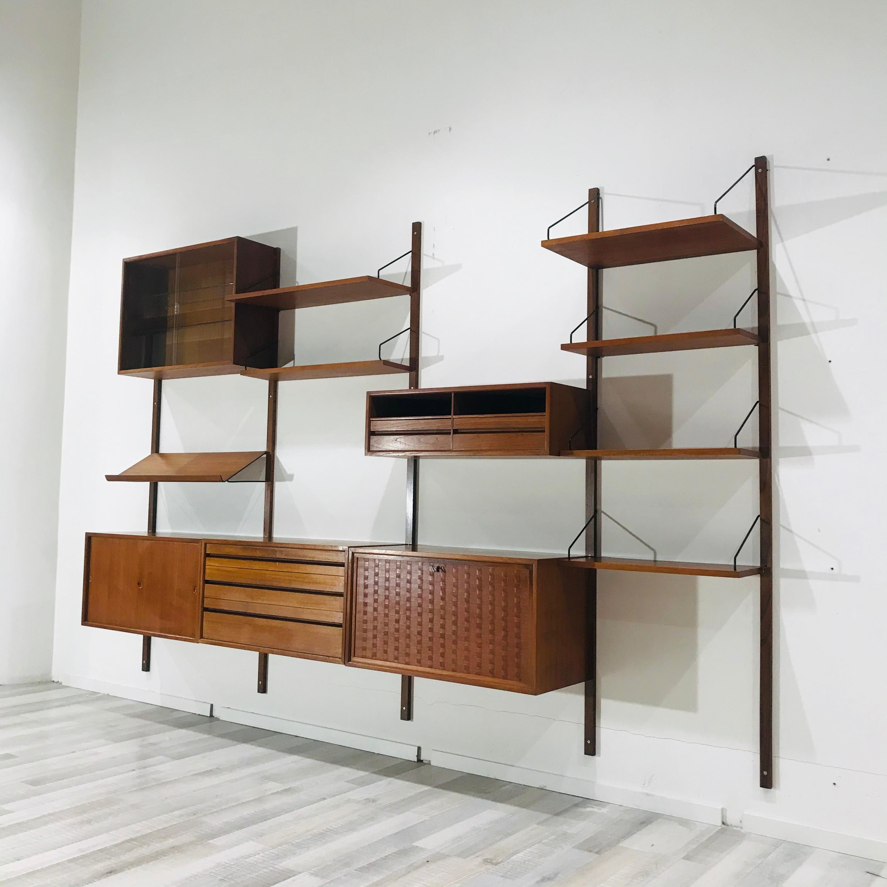 This large teak wall system was designed in 1948 by Poul Cadovius in Denmark. The 