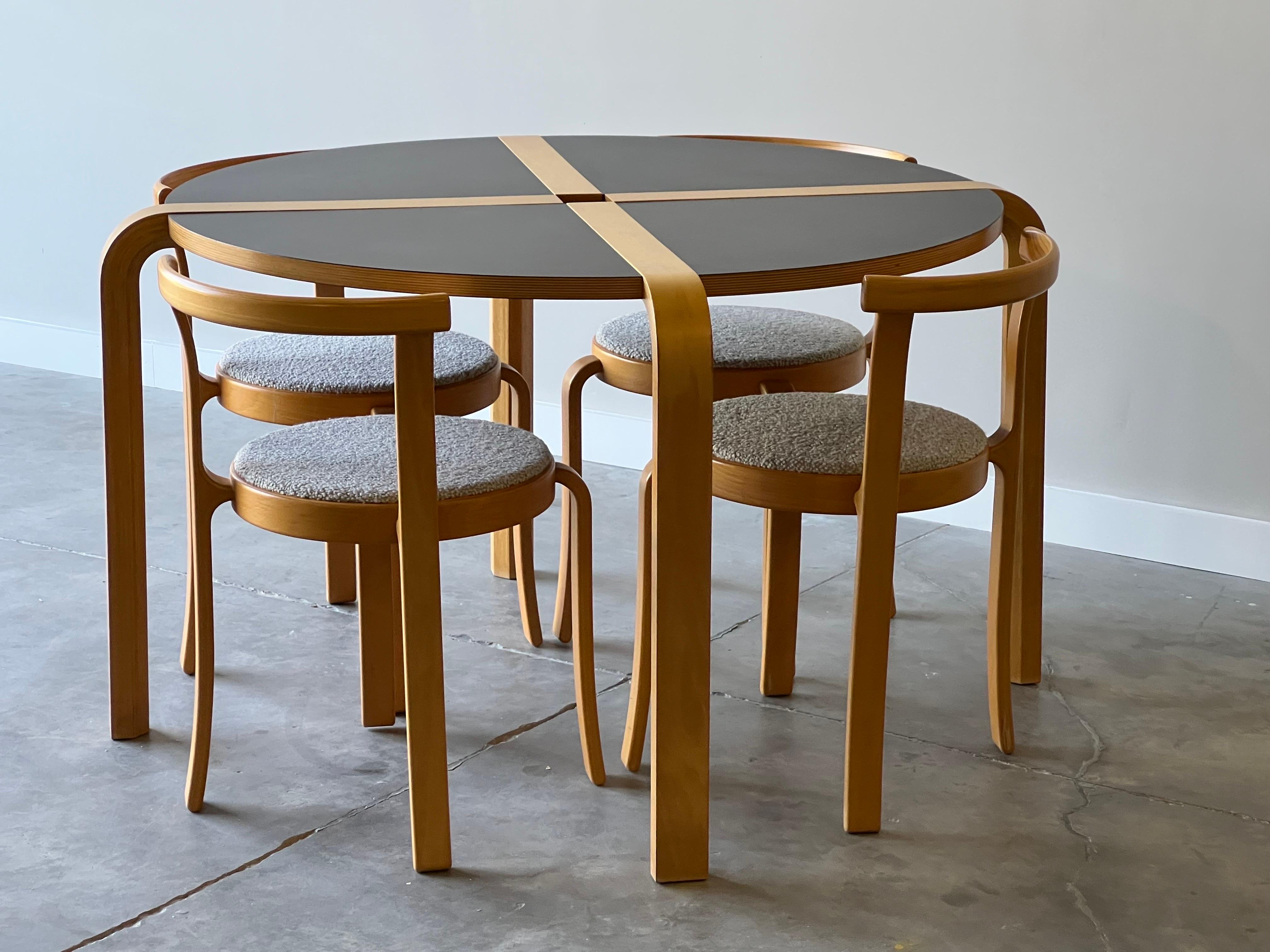 Magnificent and ultra sleek Danish Series 8000 dining set designed by Rud Thygesen and Johnny Sorensen for Magnus Olesen circa 1980s.

This design is sooooooo amazing with perfect bent beech wood and clean lines. Each chair stacks and has been newly