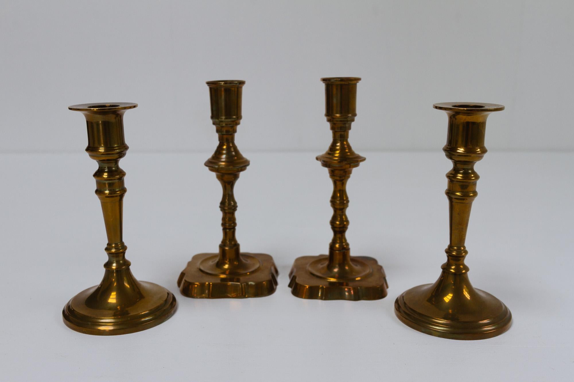 Vintage Danish Malm Candle Holders, 1950s. Set of 4.
Two pairs of candleholders in malm, which is a brass alloy with added copper. The cobber gives the brass a darker color. 
The height is 15 and 16.5 centimeters. Manufactured in Denmark in the mid