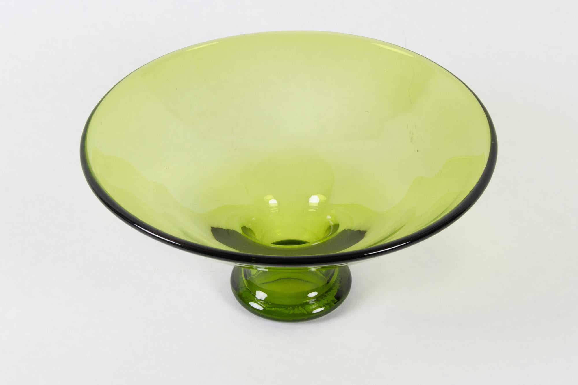 Vintage Danish Maygreen glass bowl by Per Lütken for Holmegaard 1950s
Large centerpiece bowl in green glass designed by Danish artist Per Lütken in 1955. Part of the Maygreen series of different items in this particular light green nuance. This