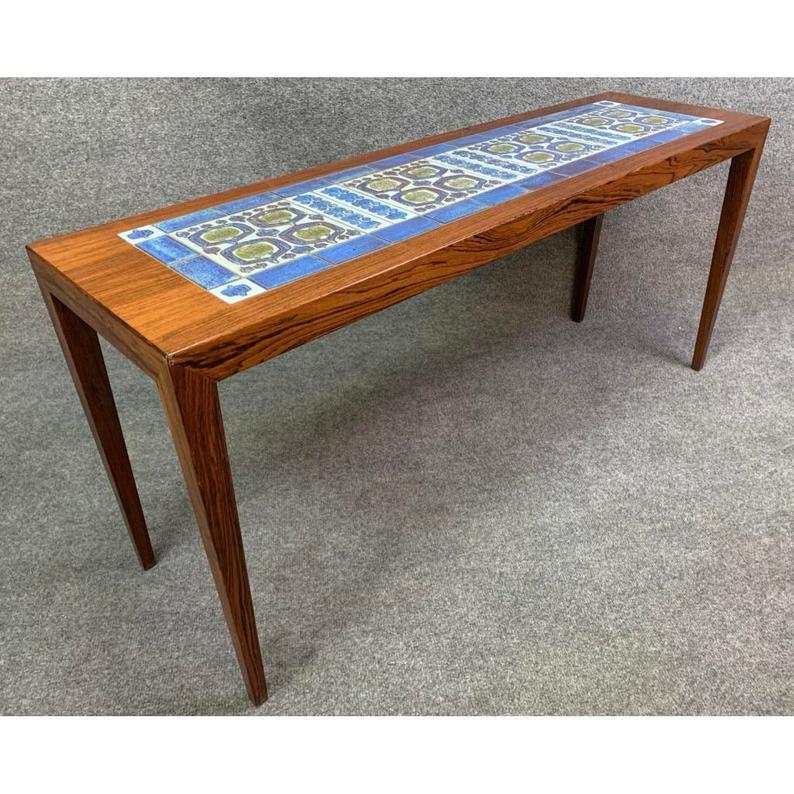 Here is a rare rosewood and porcelain “BACA” slim coffee/side table with beautiful tiles inlay designed by Severin Hansen Jr. and manufactured for Haslev Møbelsnedkeri in Denmark in the 60’s. 
This beautiful piece, recently imported from Copenhagen