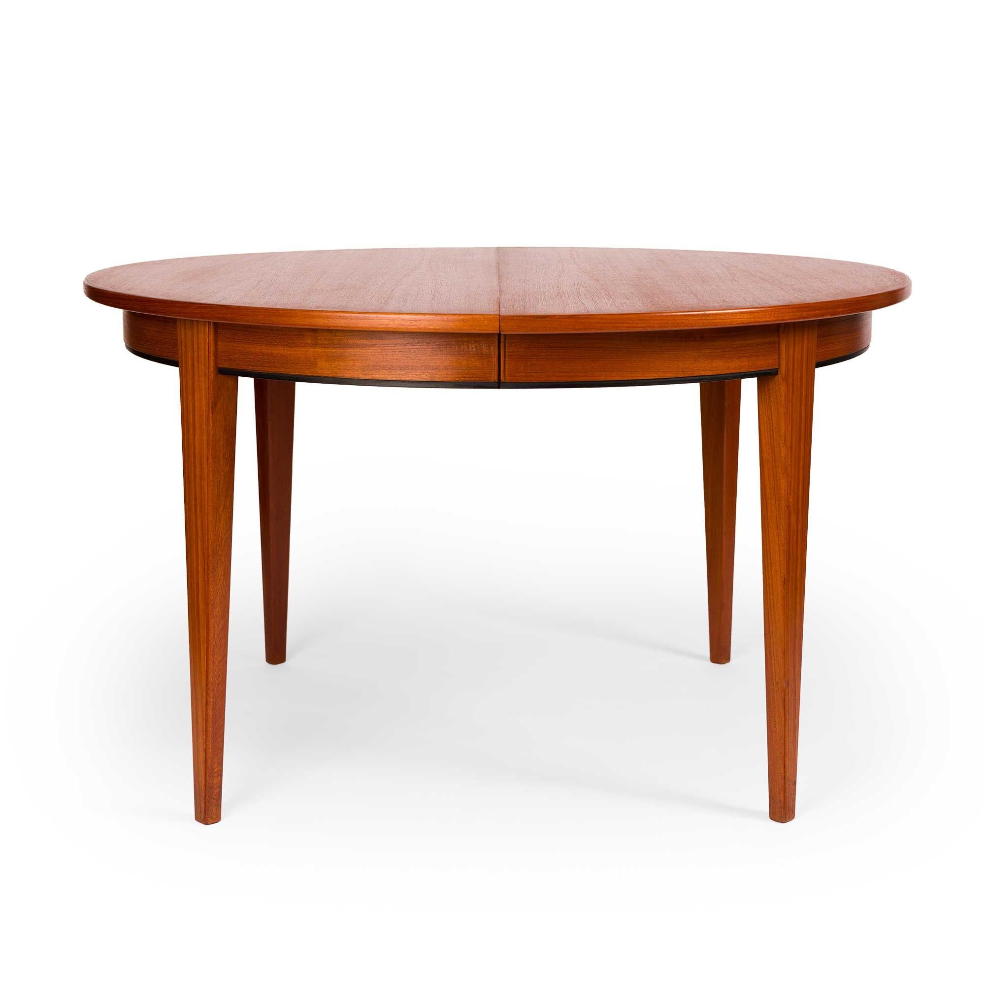 This vintage Danish mid-century teak dining table is an iconic design from the 60s. Model #55 was designed and crafted by Omann Jun for Gunni Omann. Gunni Omann was a Danish furniture designer and cabinetmaker known for his contributions to
