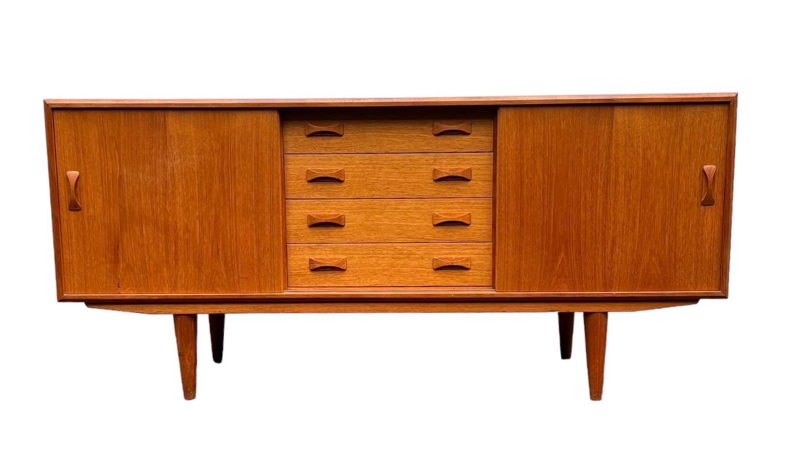 Vintage Danish Mid-Century Modern Credenza by Clausen and Sons . Dovetail Drawers. Adjustable Shelves.

Dimensions. 63 W ; 18 D ; 29 H
Right and Left Compartment. 20 D ; 16 1/2 D ; 17 1/2 H.