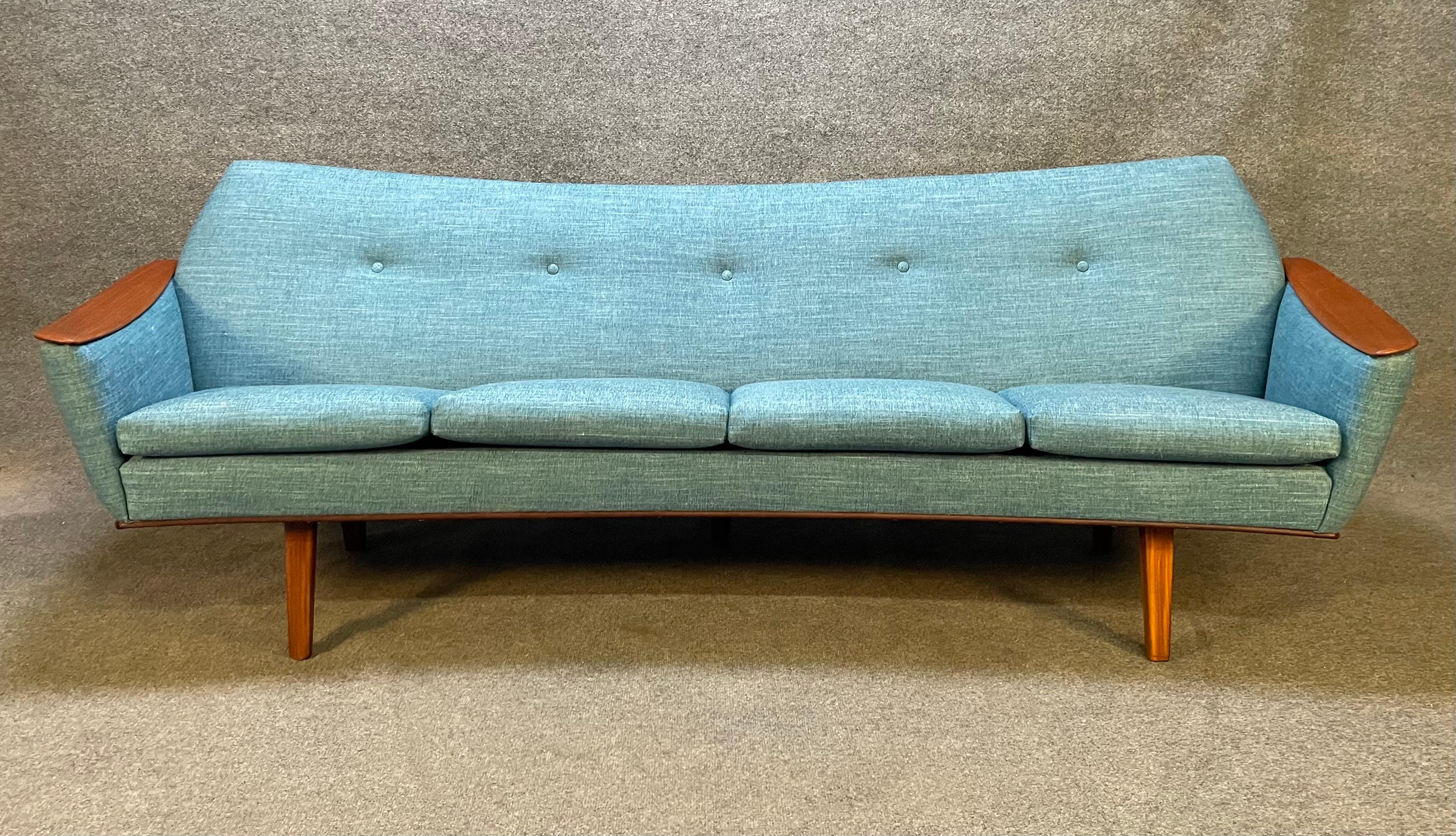 Here is a beautiful scandinavian modern sofa manufactured in Denmark in the 1960's.
This fully restored and comfortable couch, recently imported from Europe to California, features organic curves lines, teak paws and legs with brand new blue-teal