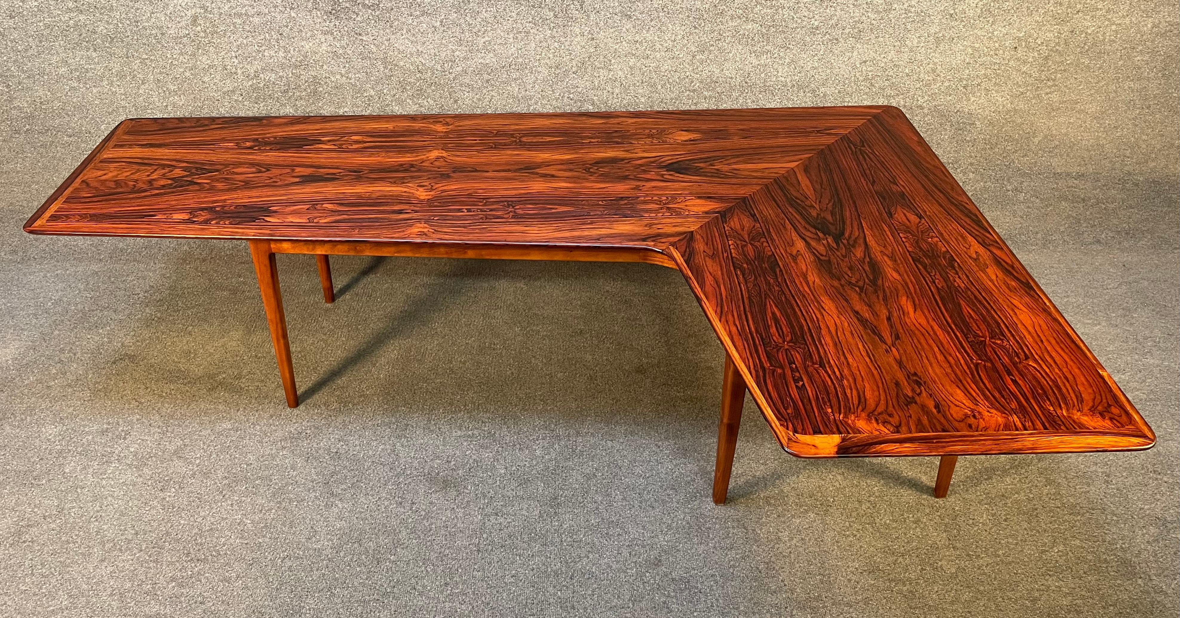 Here is an incredible Scandinavian modern cocktail table in rosewood manufactured in Denmark in the 1960's.
This special table, recently imported from Europe to California before its refinishing, feature a large top in the shape of a boomerang,