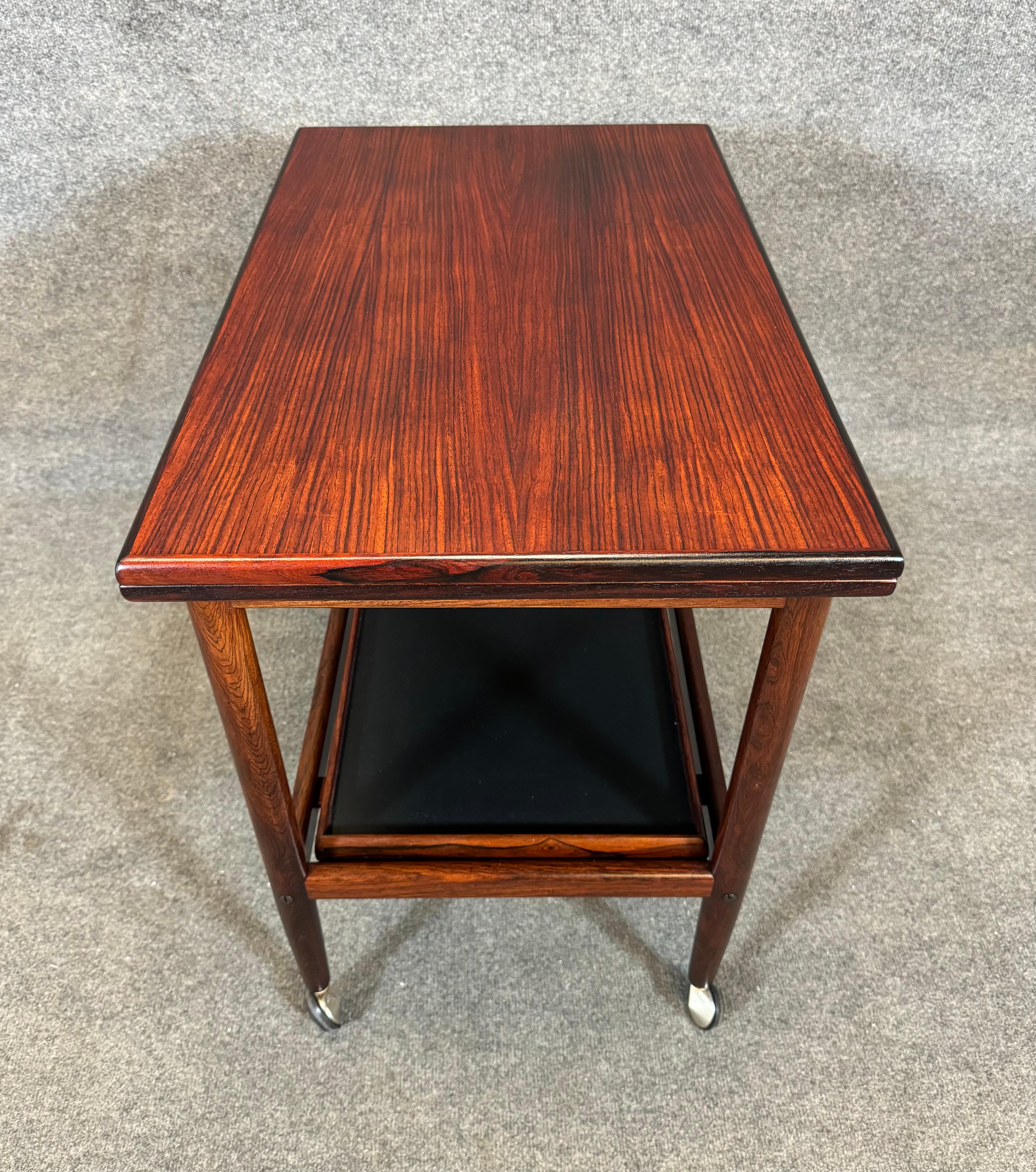 Here is a beautiful scandinavian modern cocktail cart in rosewood designed by Grete Jalk and manufactured by Poul Jeppesen in Denmark in the 1960's.
This exquisite piece, recently imported from Europe to California before its refinishing, features a
