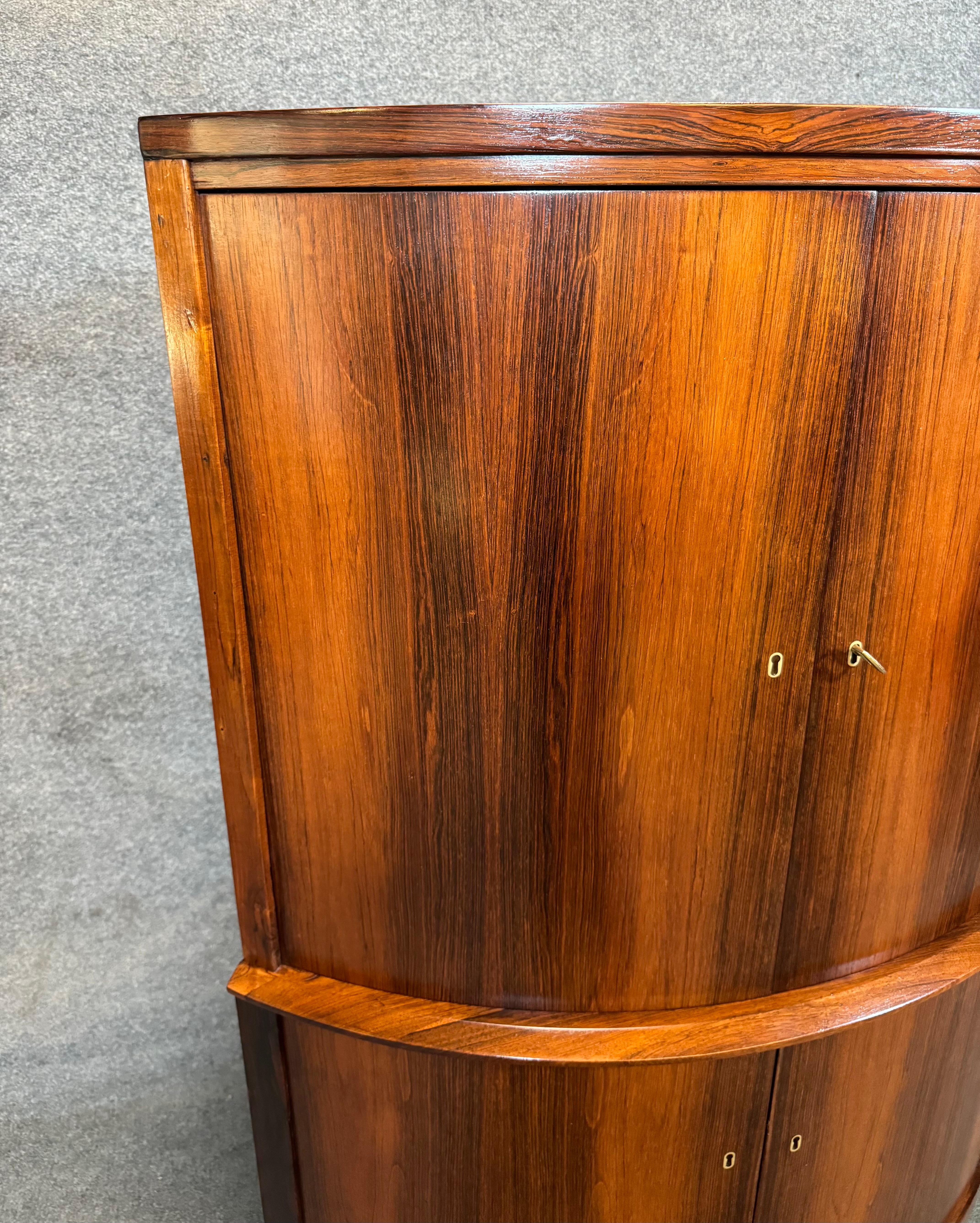 Here is a beautiful scandinavian modern corner cabinet in rosewood attributed to designer Agner Christoffersen and manufactured in Denmark in the 1960's.
This lovely piece, recently imported from Europe to California before its refinishing, features