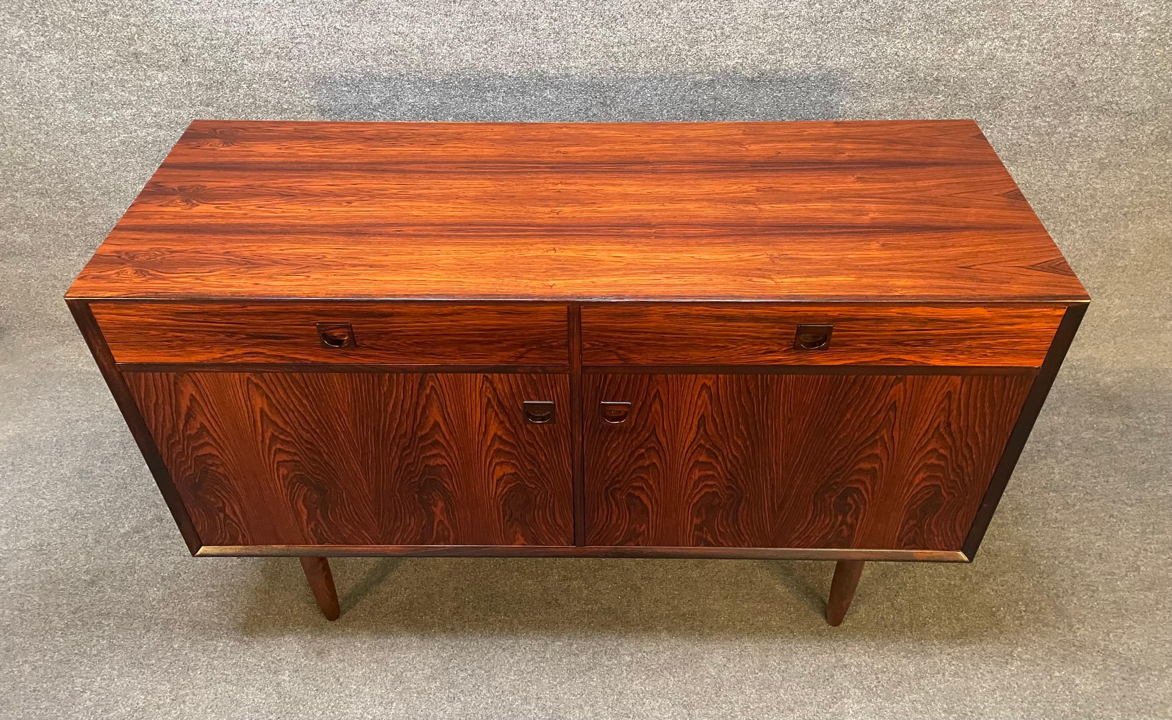 Here is a beautiful scandinavian modern rosewood compact sideboard manufactured by Brouer Mobelfabrik in Denmark in the 1960's.
This exquisite piece, recently imported from Europe to California before its refinishing, features a vibrant wood grain,