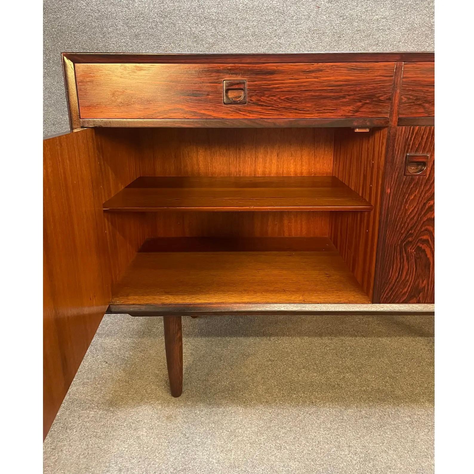 Here is a beautiful scandinavian modern rosewood compact sideboard manufactured by Brouer Mobelfabrik in Denmark in the 1960's. This exquisite piece, recently imported from Europe to California before its refinishing, features a vibrant wood grain,