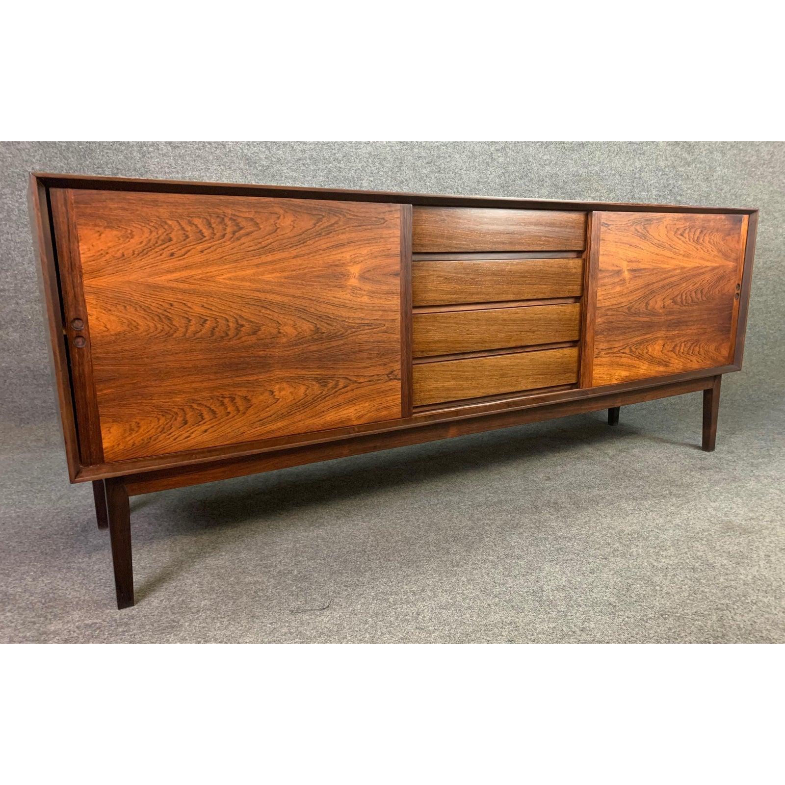 Here is a special sideboard in rosewood manufactured by Hornslet Mobelfarik in Denmark in the 1960s.
This exquisite piece features a vibrant wood grain, a flushed marble tray/insert on its top, two sliding doors revealing storage with adjustable