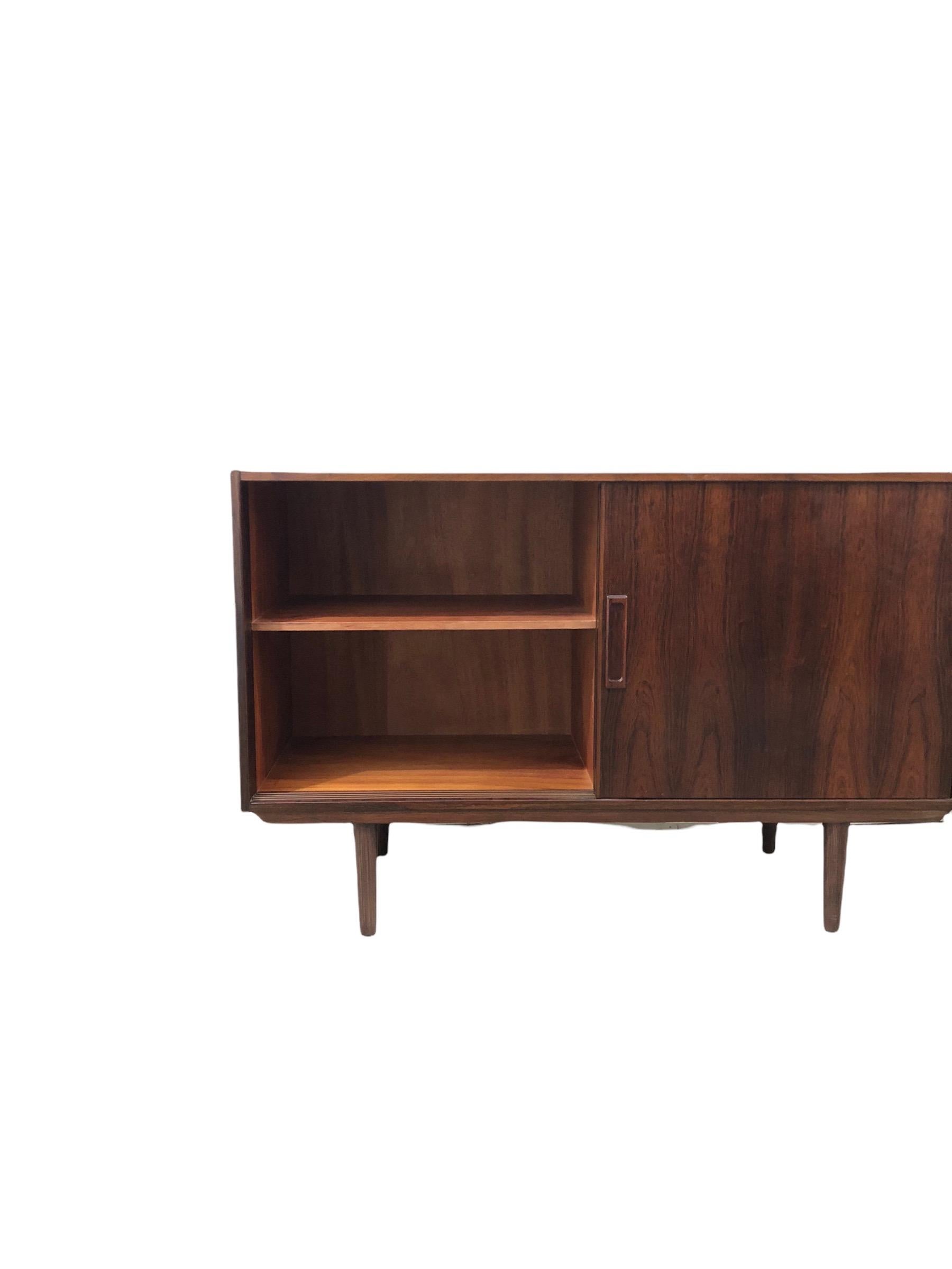 Mid-Century Danish Modern Rosewood cabinet in style of Kai Kristiansen, manufactured in Denmark with adjustable shelf, with two sliding doors, raised on tapered legs. Cabinet could be use as entry way cabinet or as media cabinet

Dimensions: 47 W