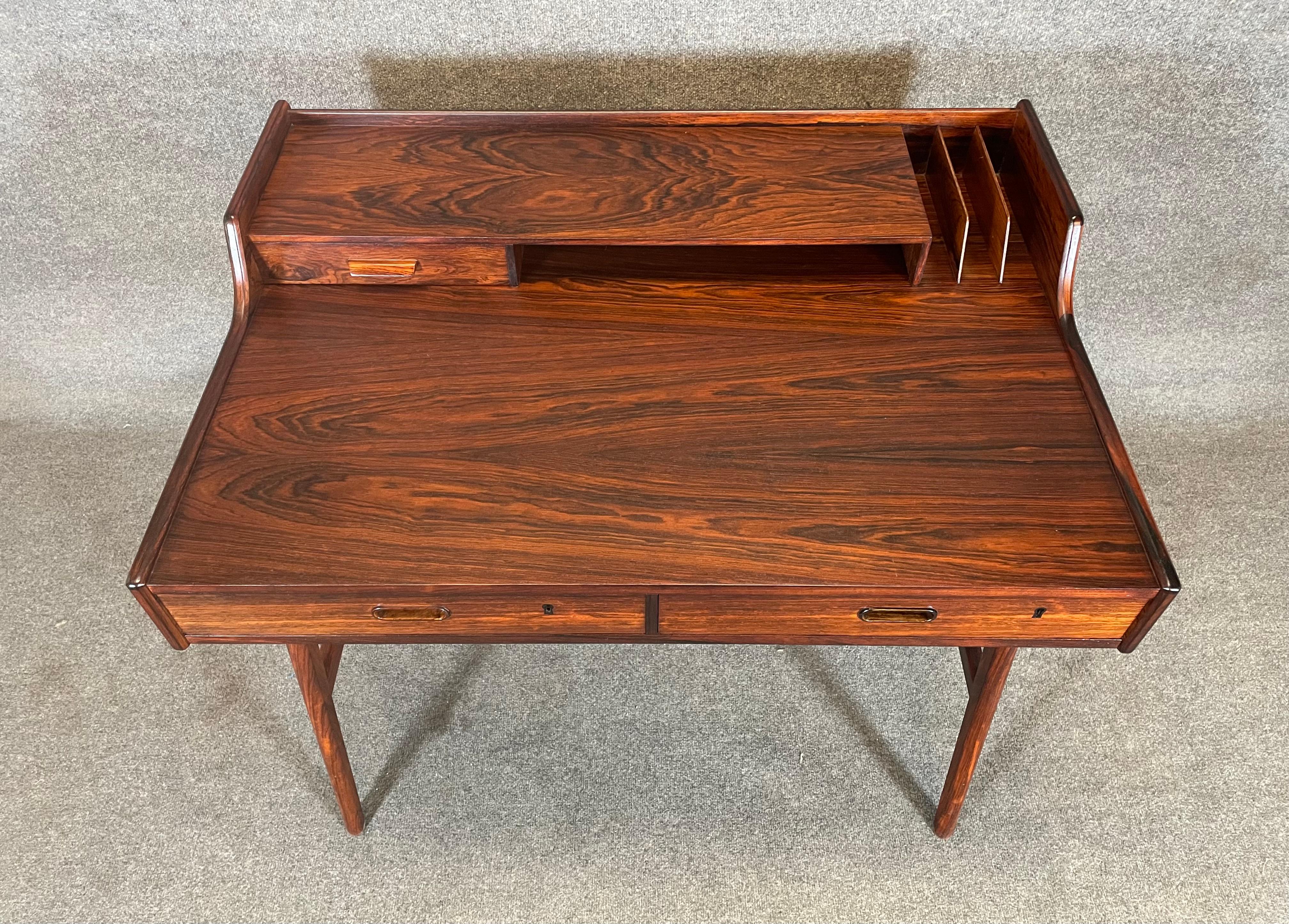 Here is the sought after scandinavian modern Model 56 desk in rosewood designed by Arne Wall Iversen and manufactured by Vinde Mobelfabrik in Denmark in the 1960's.
This exquisite desk, recently imported from Europe to California before its