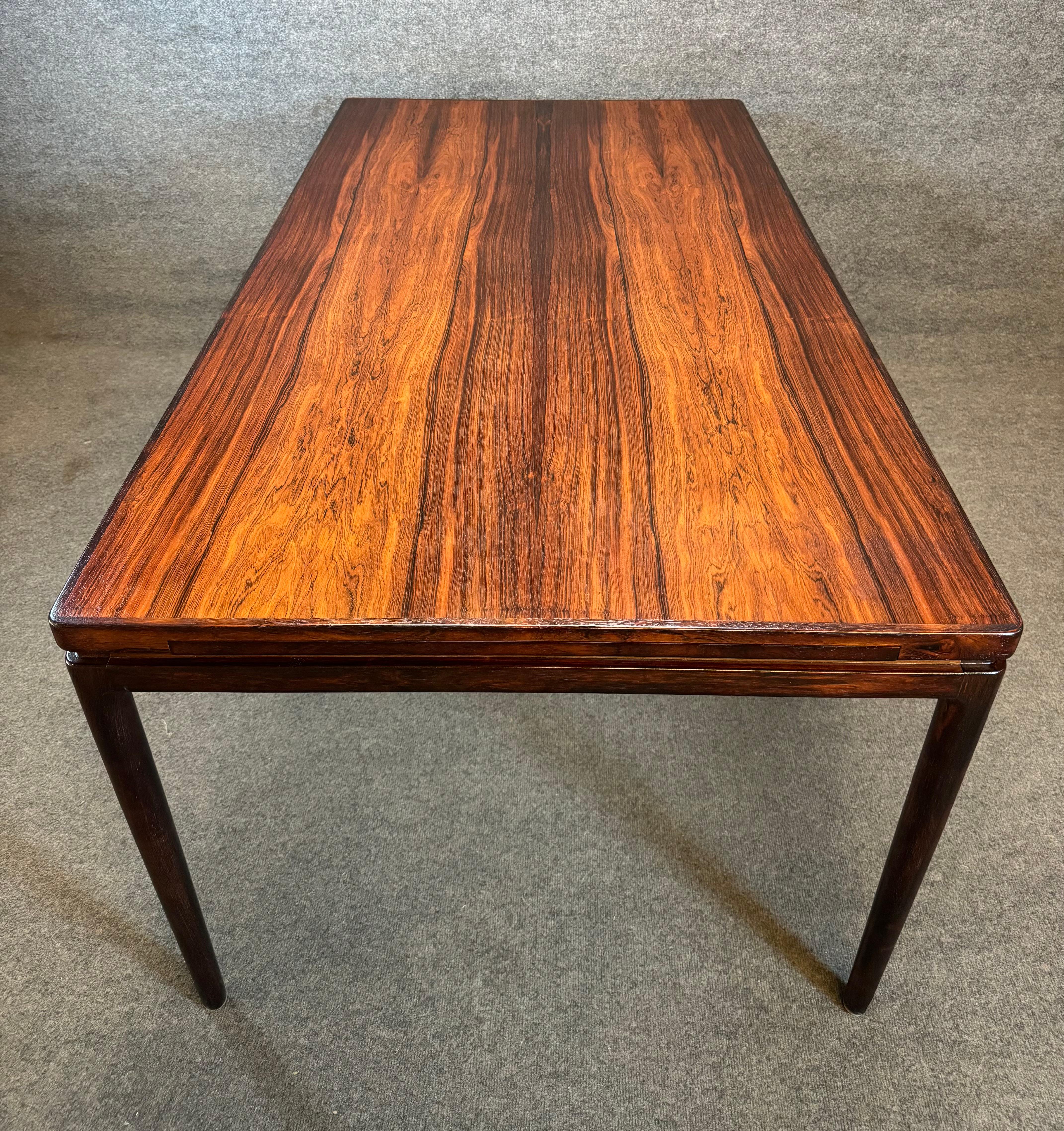 Here is a beautiful Scandinavian modern large dining table in rosewood designed by Johannes Andersen and manufactured by Christian Linneberg in Denmark in the 1960's.
This exquisite table, recently imported from Europe to California before its
