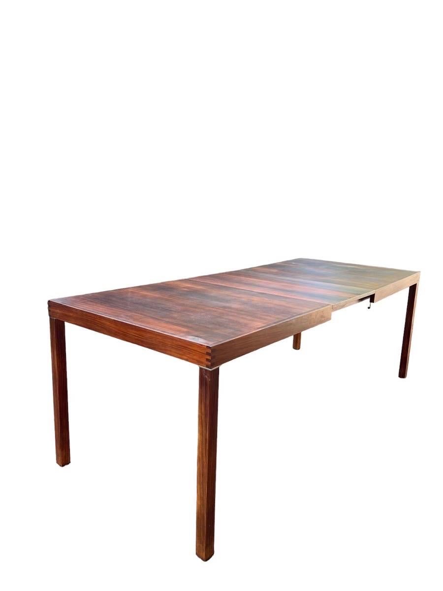 Vintage Danish Mid-Century Modern Rosewood Dining Table Parsons with Extension Leaf.
Dimensions. 63 W; 33 1/2 D; 28 1/2 H
Extended. 82.75 W
Knee Clearance. 25.75.