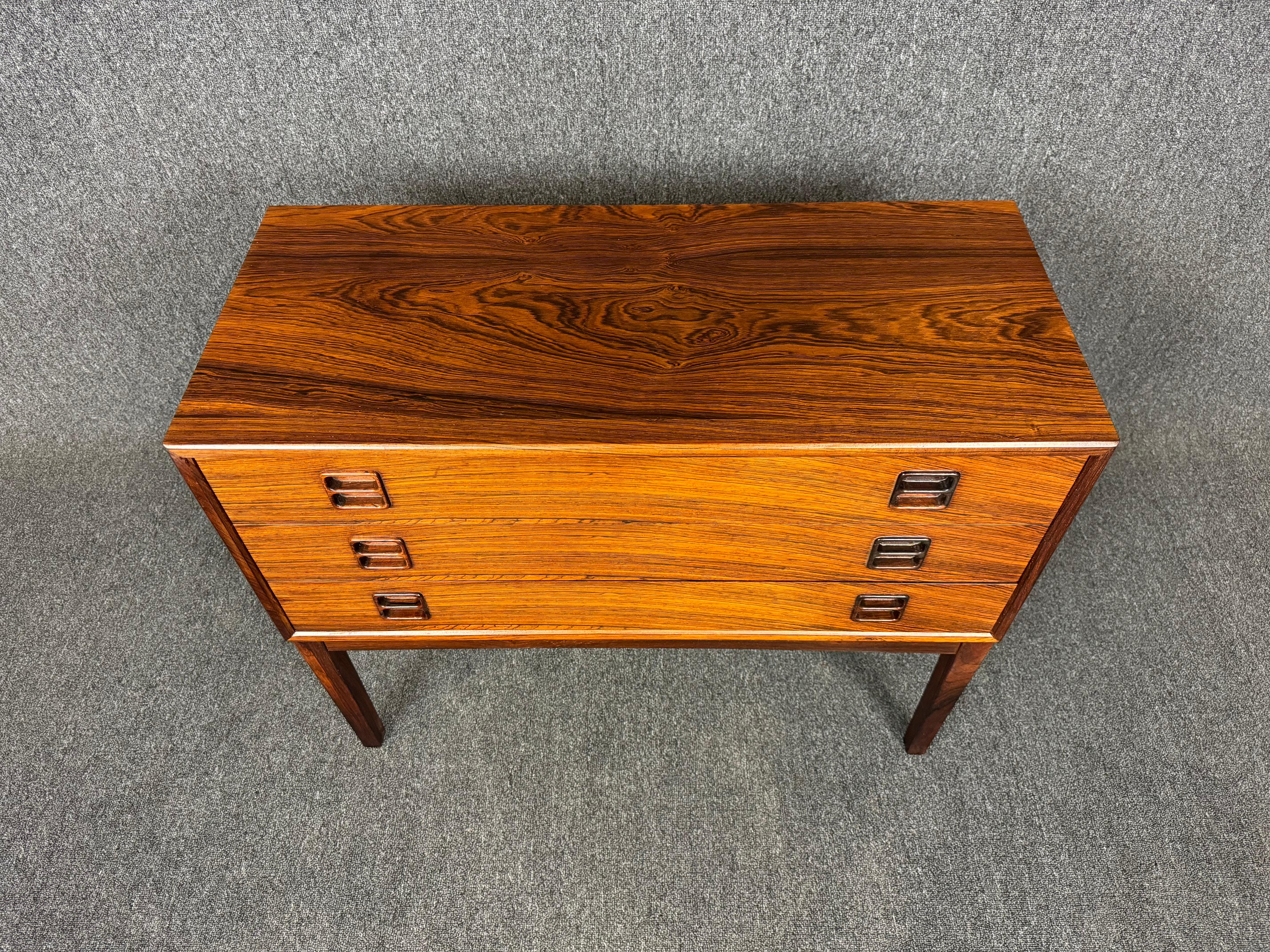 Here is a lovely Scandinavian modern entry chest - side table - nightstand in rosewood manufactured by Brouer Mobelfabrik in Denmark in the 1960's.
This exquisite case piece, recently imported from Europe to California before its refinishing,